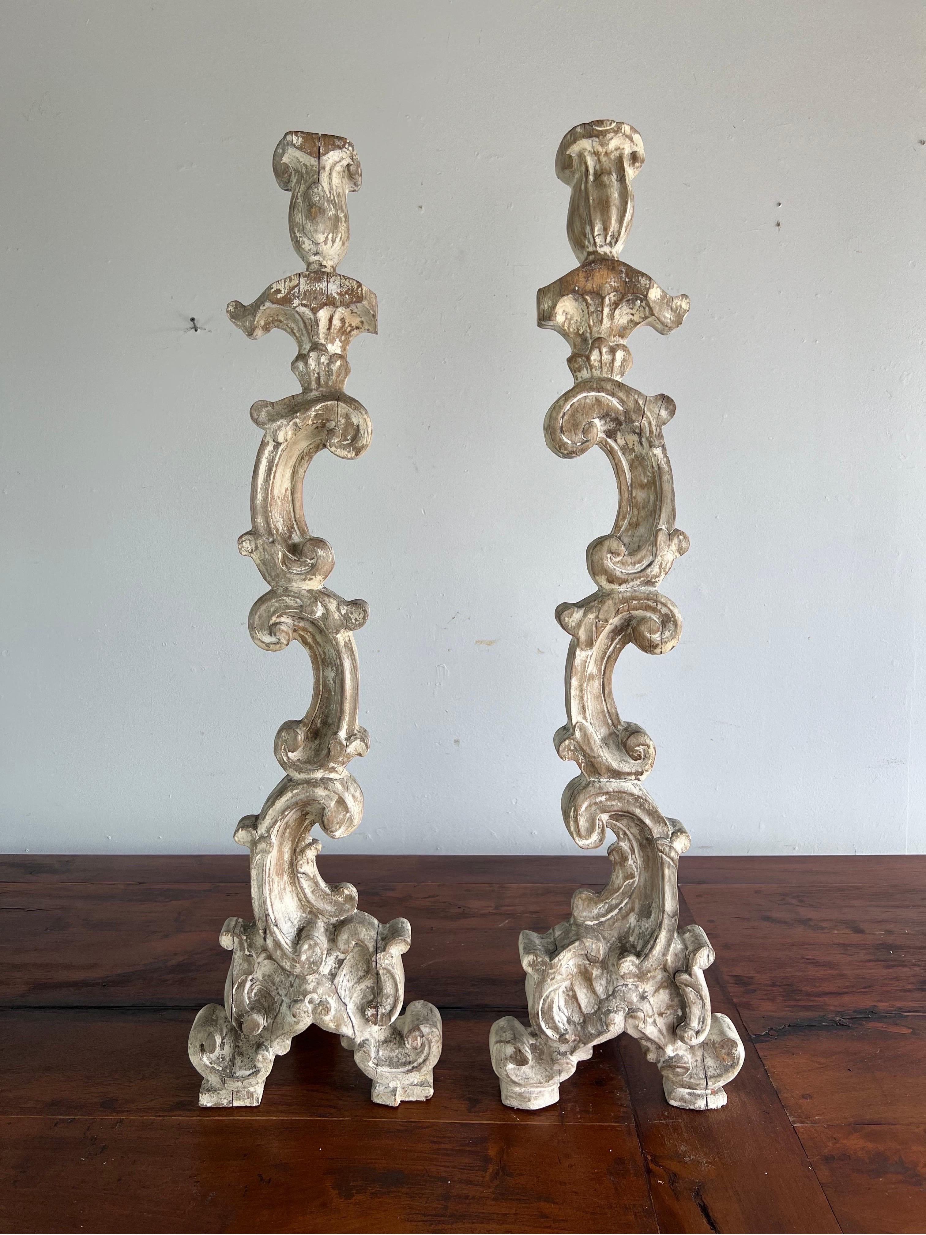 Monumental size Italian painted candlesticks. The candlesticks are beautifully carved depicting connecting acanthus leaves throughout. The paint is softly worn and is an antique white and gray coloration.
