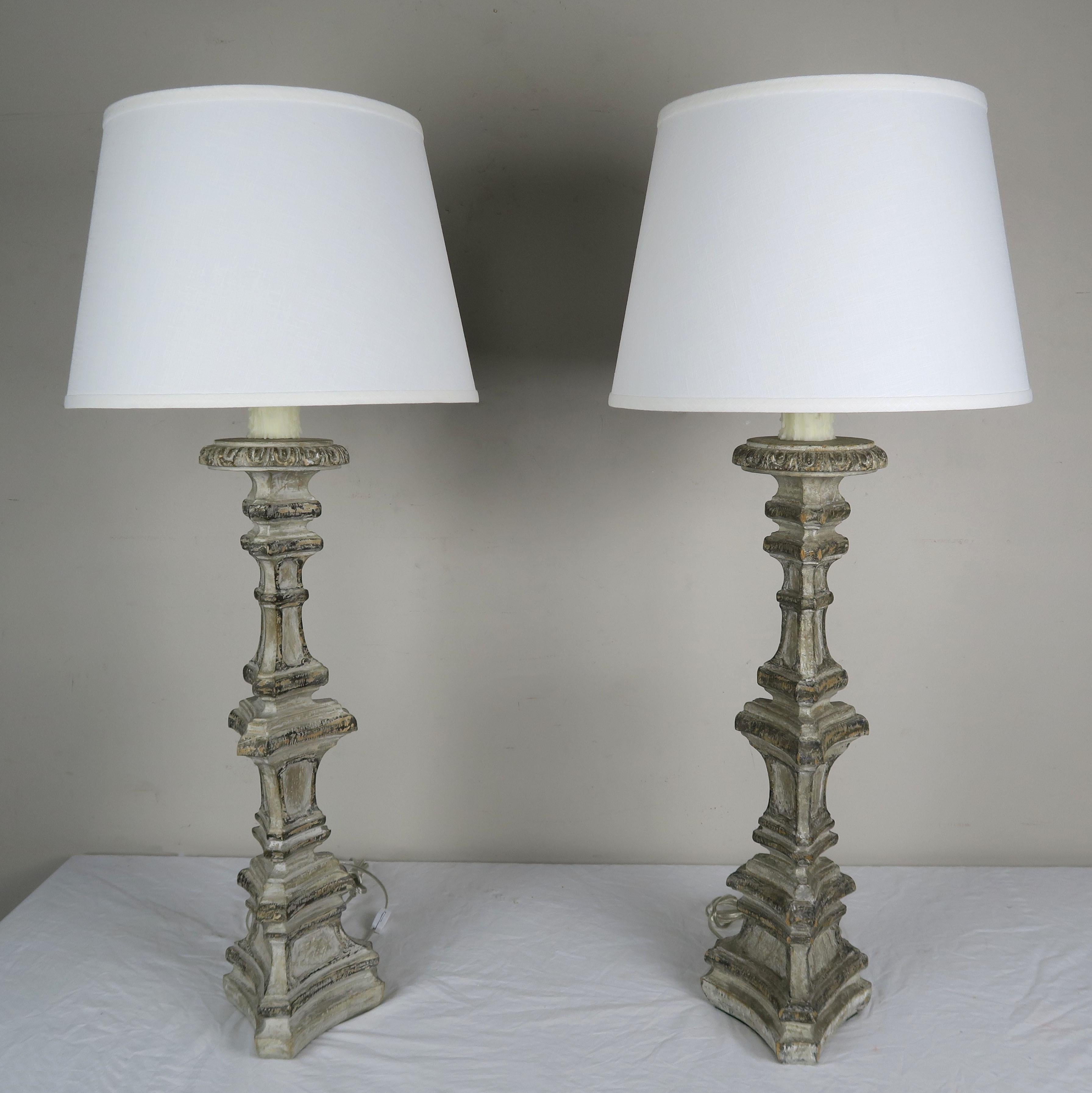 Pair of Italian painted candlesticks that have been wired into lamps and crowned with crisp white linen shades.