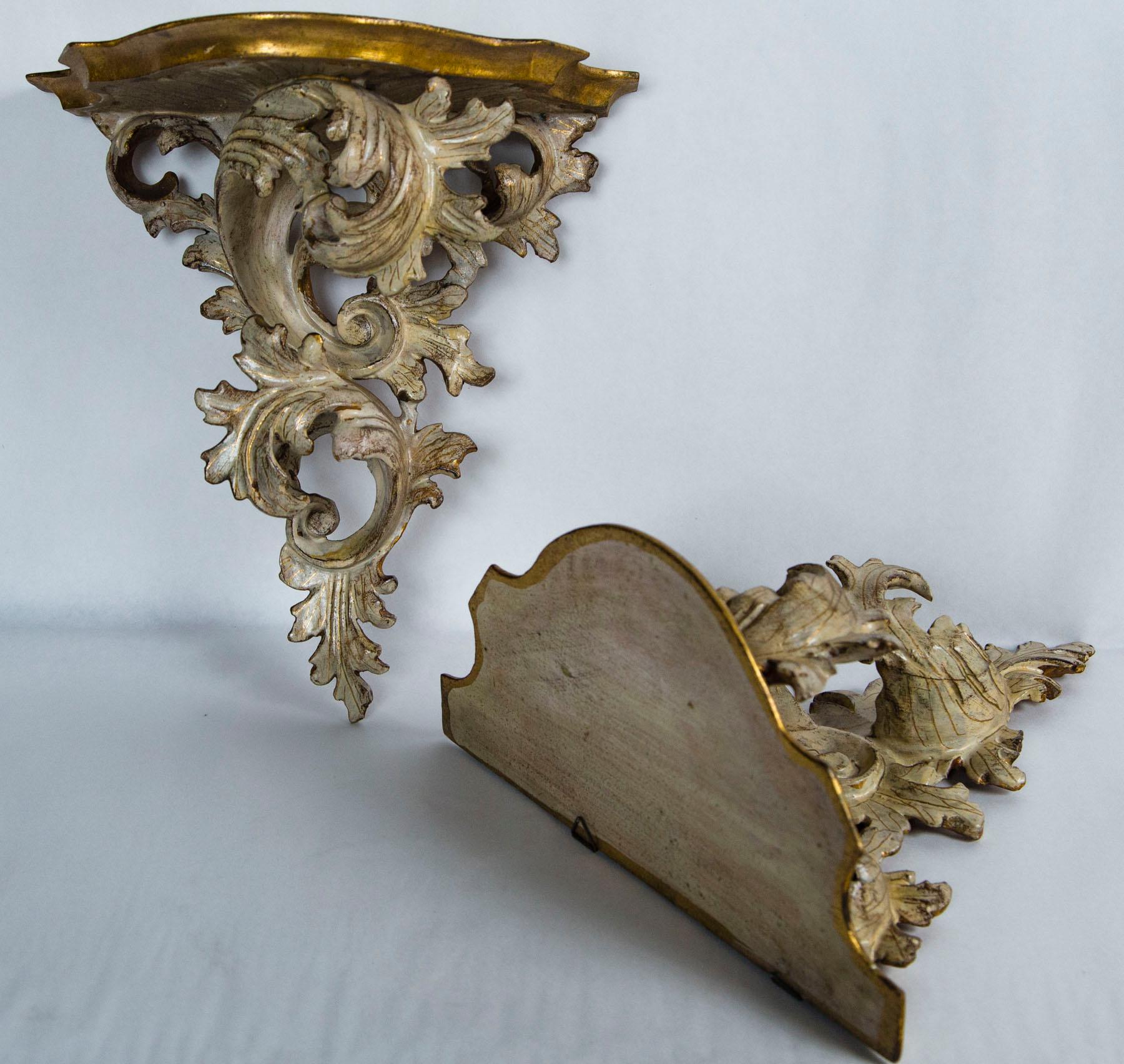 In the Rococo style with a cartouche shaped top, and scrolls of leaves.