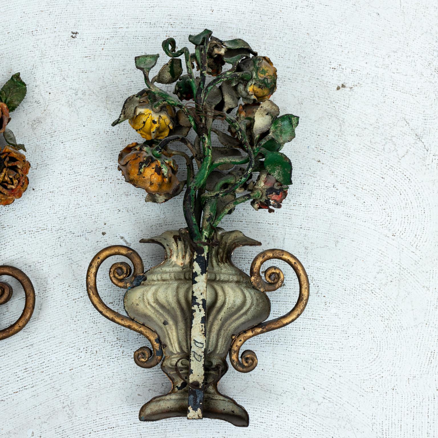 Pair of Italian painted floral urn gardeners in wrought iron, circa 19th century. The pieces also feature s-scroll shaped handles. Please note of wear consistent with age including patina, paint, and finish loss.