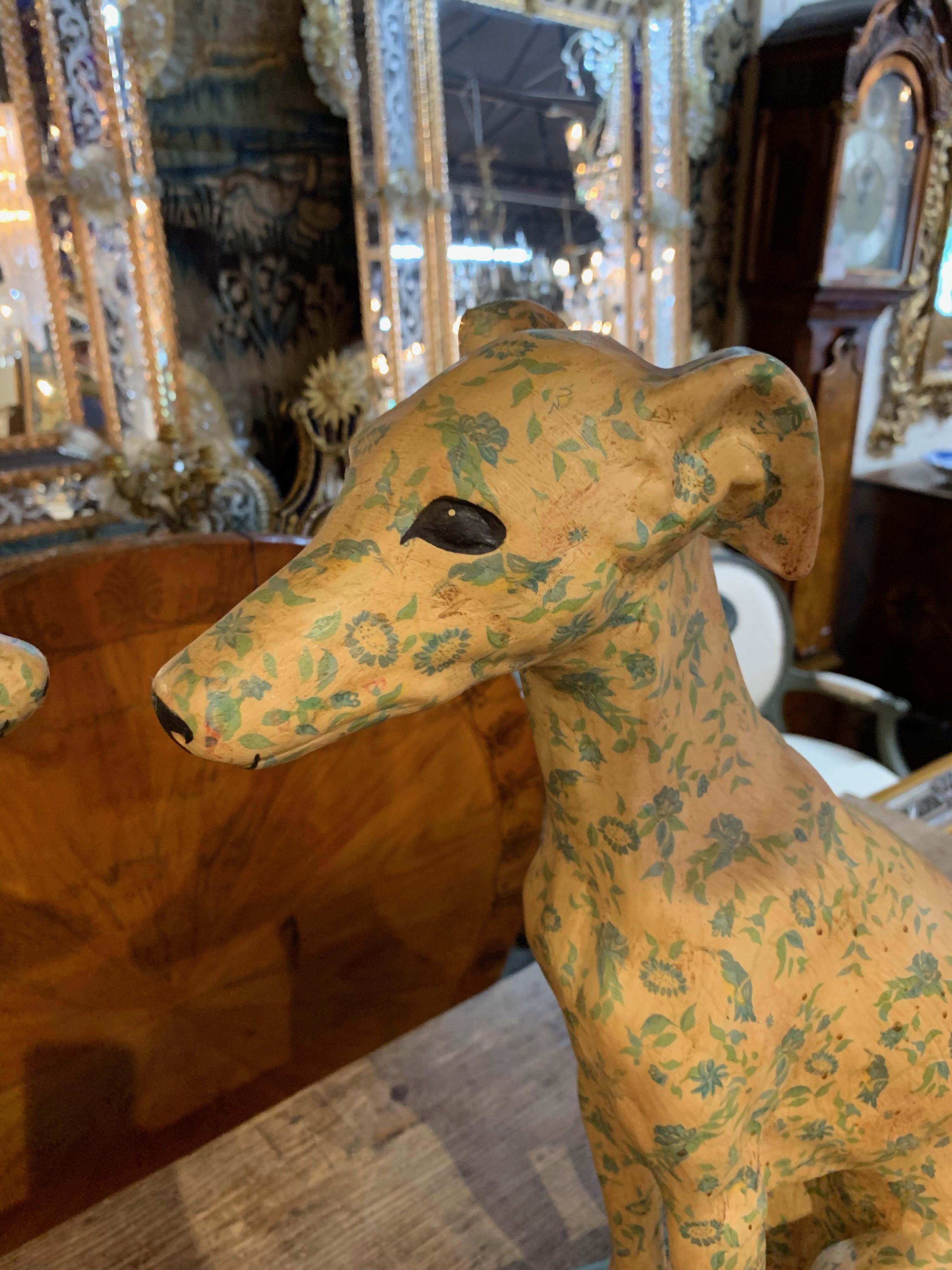 Very nice pair of terracotta whippets. They are hand painted in a floral pattern with blue and rose colored flowers. Great quality and detail on these whimsical items!