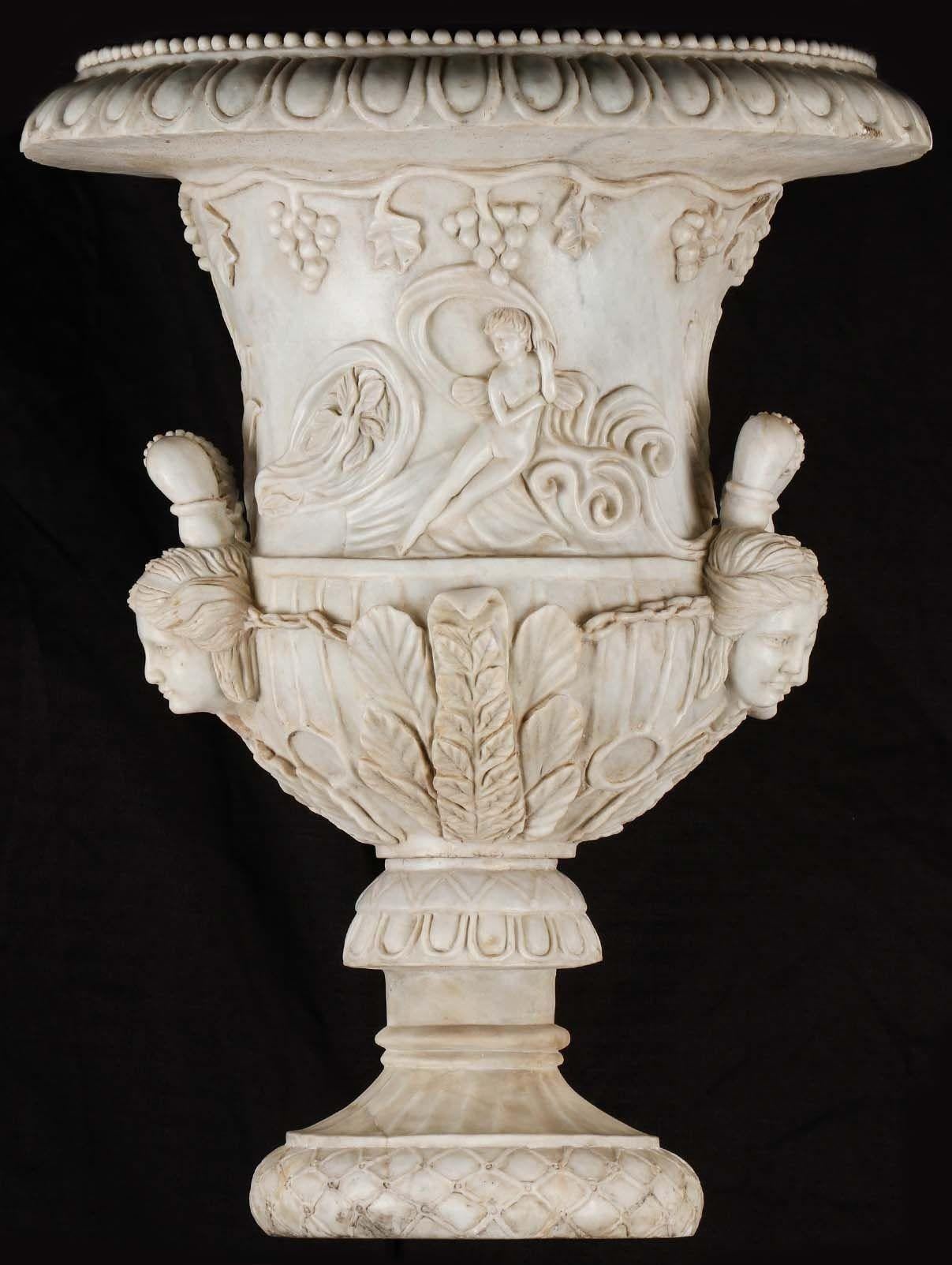 Pair of beautiful bell-shaped palatial garden urns carved with fine white marble depicting classical imagery of female figures and grapevines. Inspired by the ancient Roman-era Medici vase. 
Made in Italy, Late 18th-Early 19th Century.
About the
