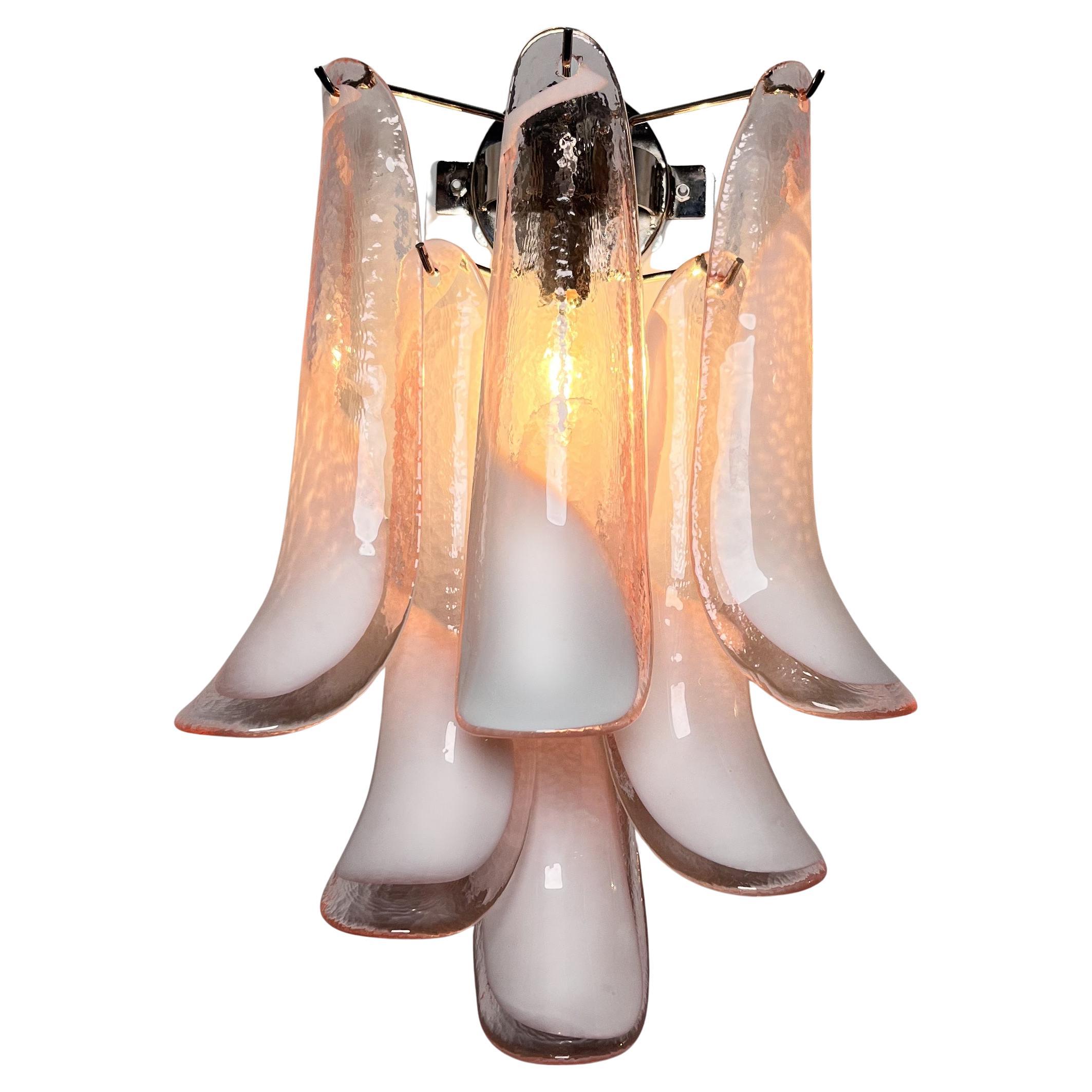 Pair of Vintage Italian Murano appliques. Wall lights have 6 pink and lattimo glass petals (for each applique) in a chrome frame.
Period: late XX century
Dimensions: 18,60 inches (48 cm) height; 12 inches (31 cm) width; 7,75 inches (20 cm) depth