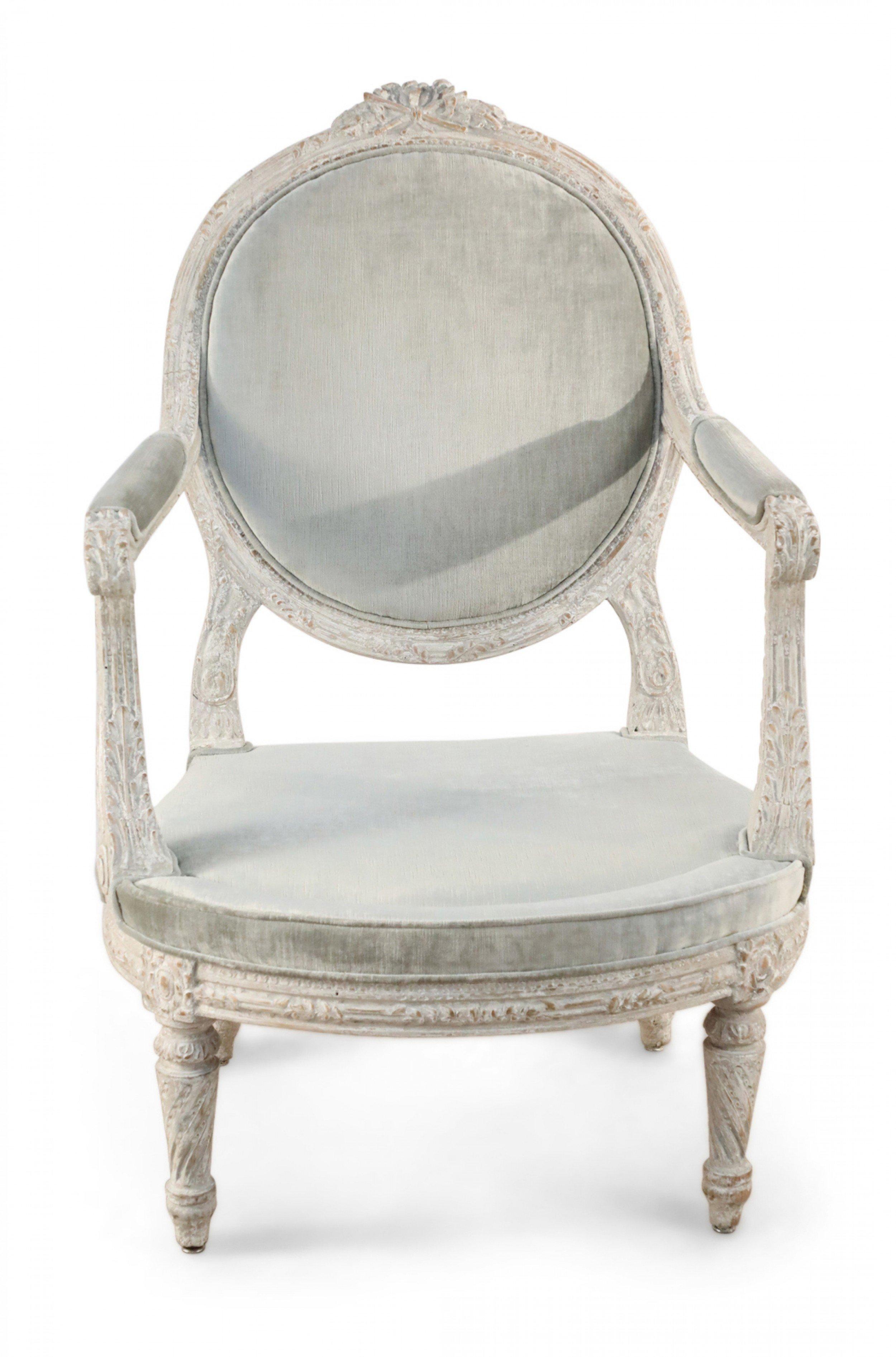 Pair of Italian Piedmontese (c.1785) open arm chairs with a rounded back having a carved floral crest, the frame carved with wheat, and the legs having a twisted fluting with light gray velvet upholstery. (PRICED AS Pair)
