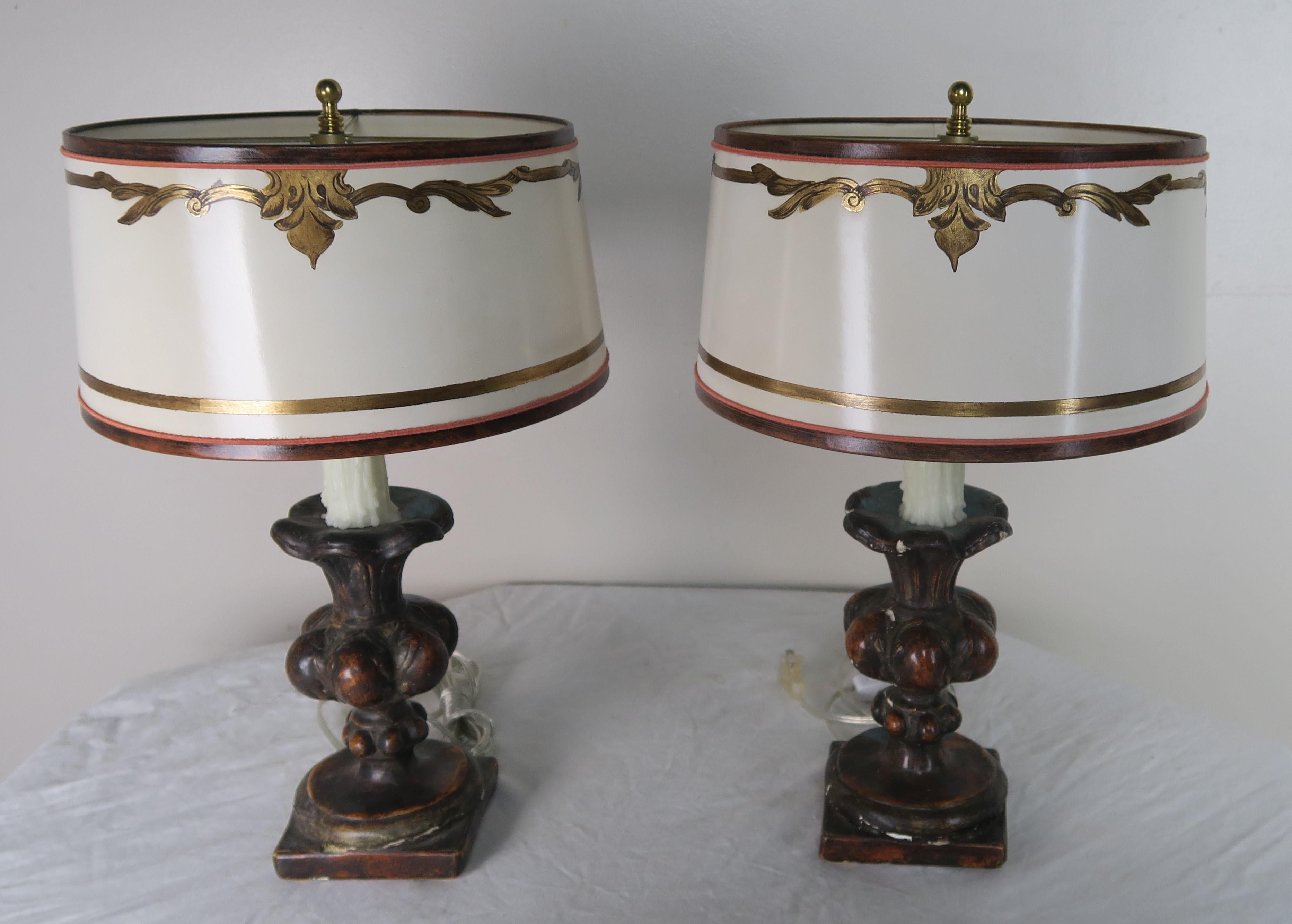 Pair of custom lamps made with 19th century carved wood polychrome candleholders wired into lamps with drip wax candles. The lamps are crowned with hand painted parchment shades. The lamps are newly rewired and are ready to install.