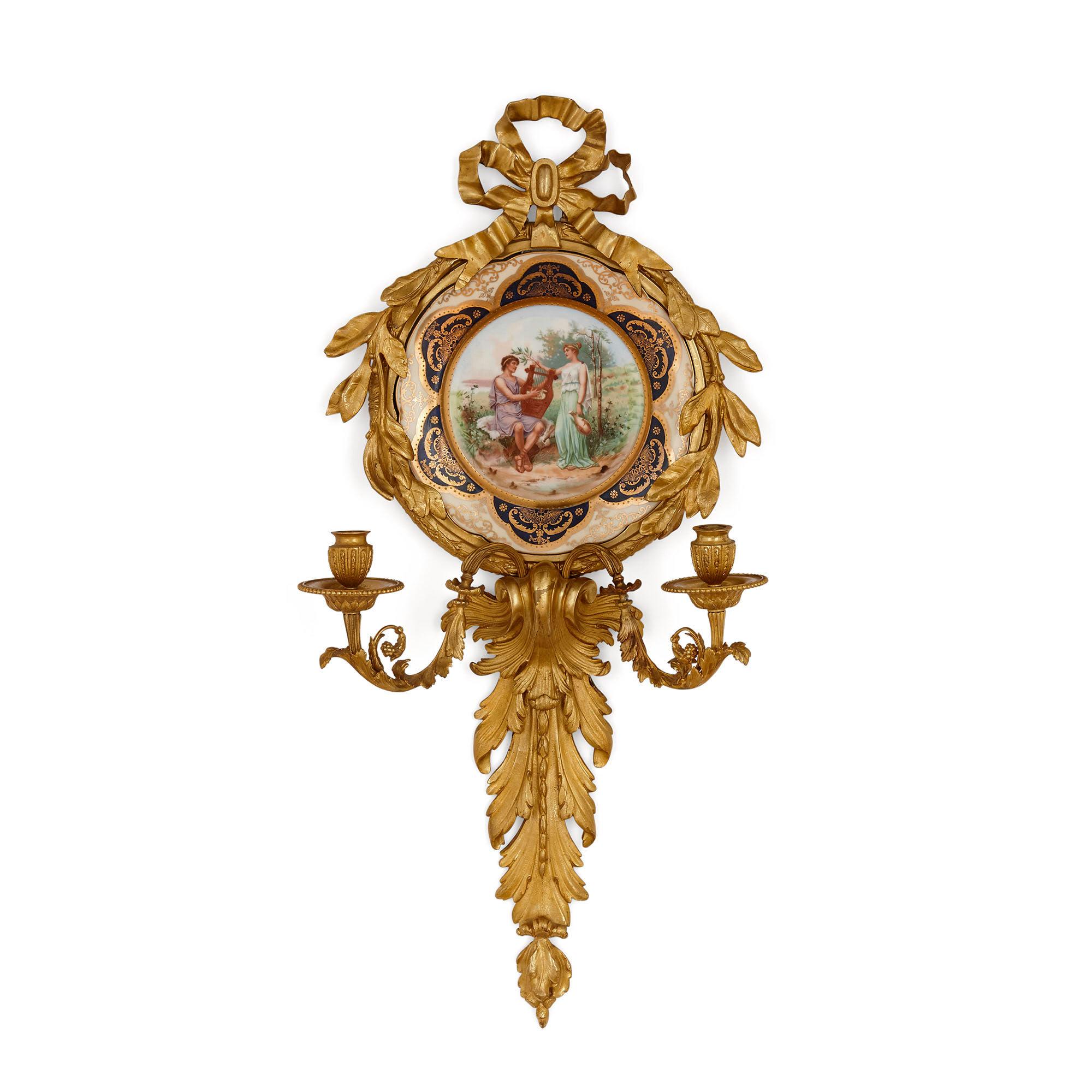 Pair of Italian porcelain and gilt bronze sconces by Pauly & Co
Italian, early 20th century
Measures: Height 77cm, width 40cm, depth 13cm

This fine pair of sconces is by the Venetian firm Pauly & Co. Each sconce features a gilt bronze frame,