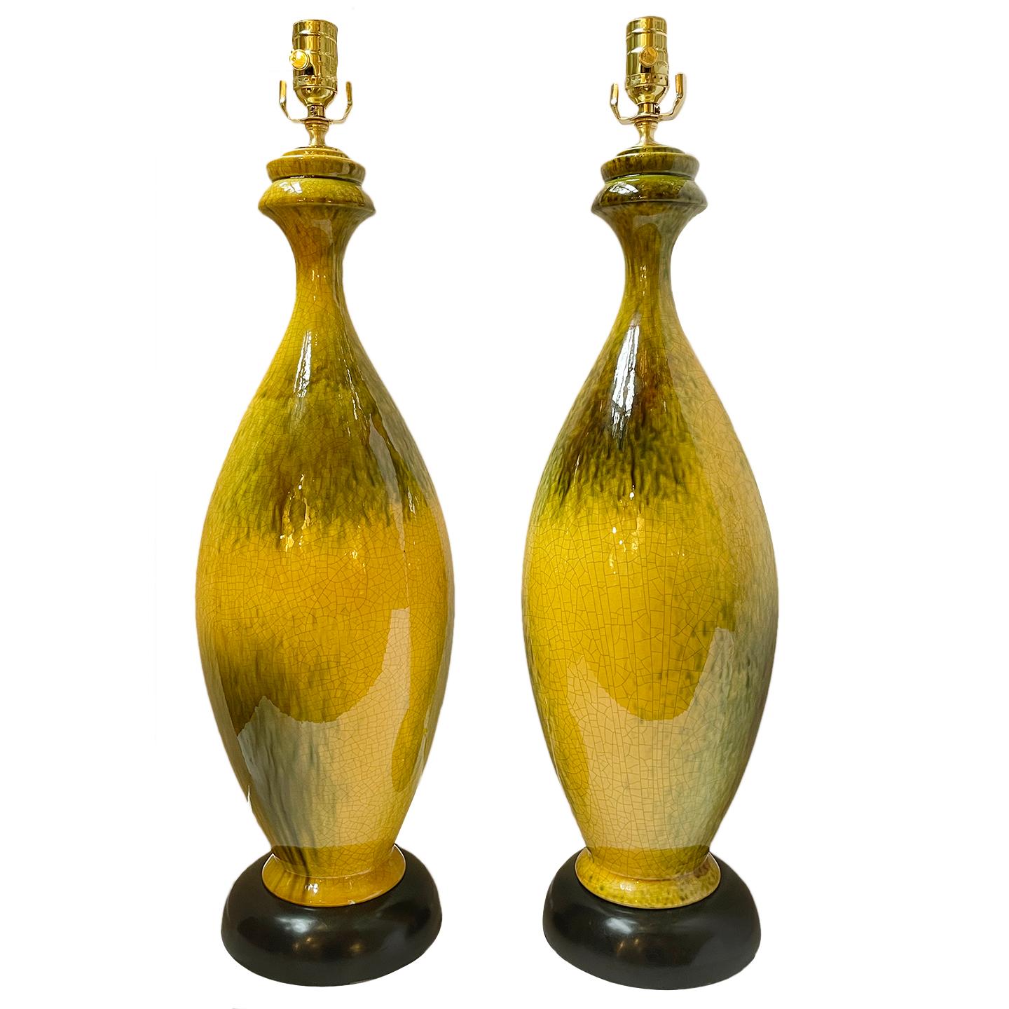 A pair of circa 1960's Italian porcelain table lamps with yellow tinted glaze.

Measurements:
Height of body: 24.5