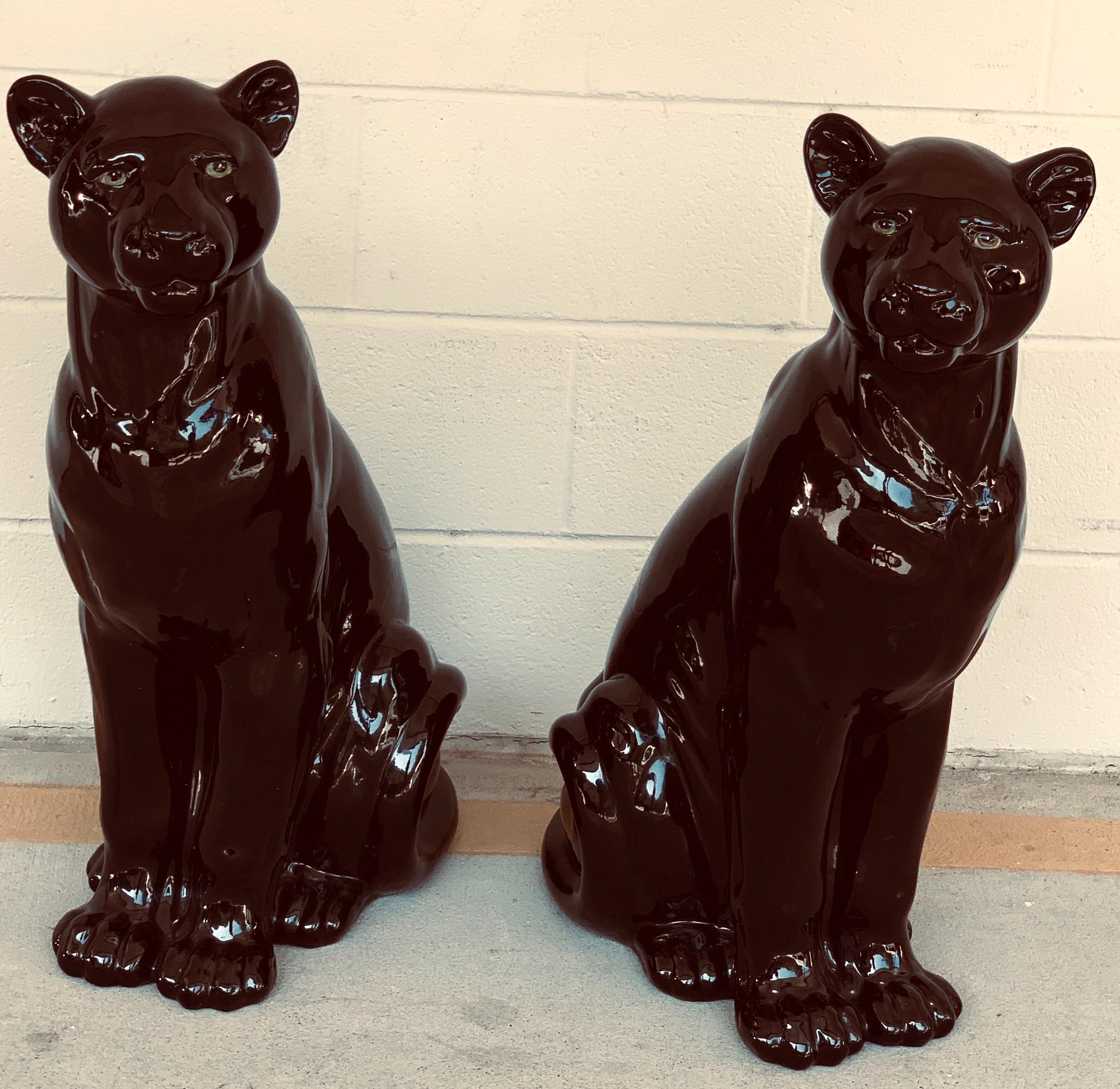 Pair of Italian porcelain seated black panthers, each one realistically modeled, with green eyes. Stamped 