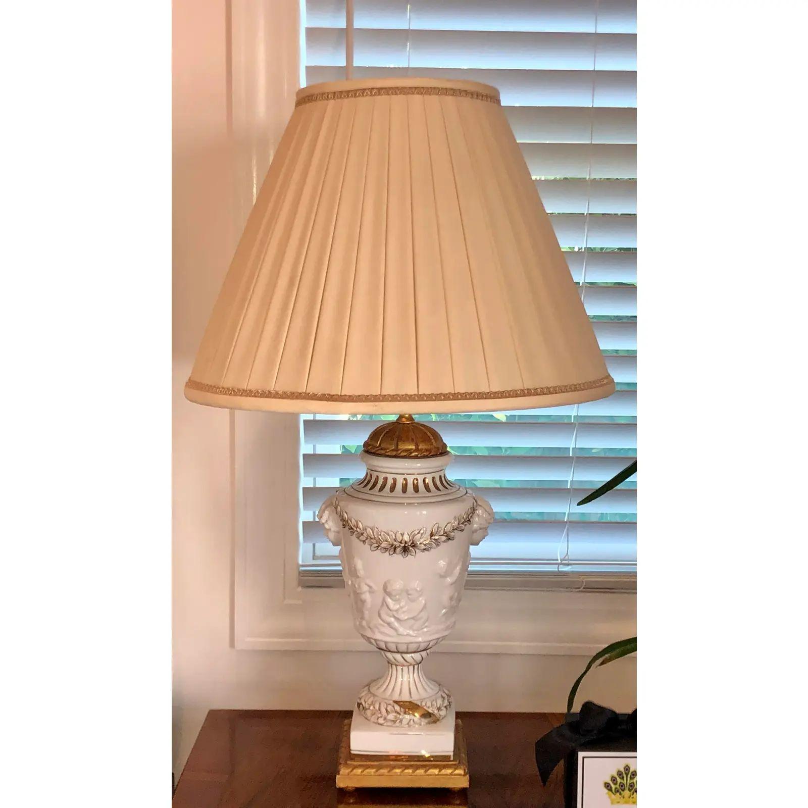 Pair of Italian Porcelain Urn Form Designer Cherub Lamps.
Total height 30”.
Each base measures 16' tall by 8