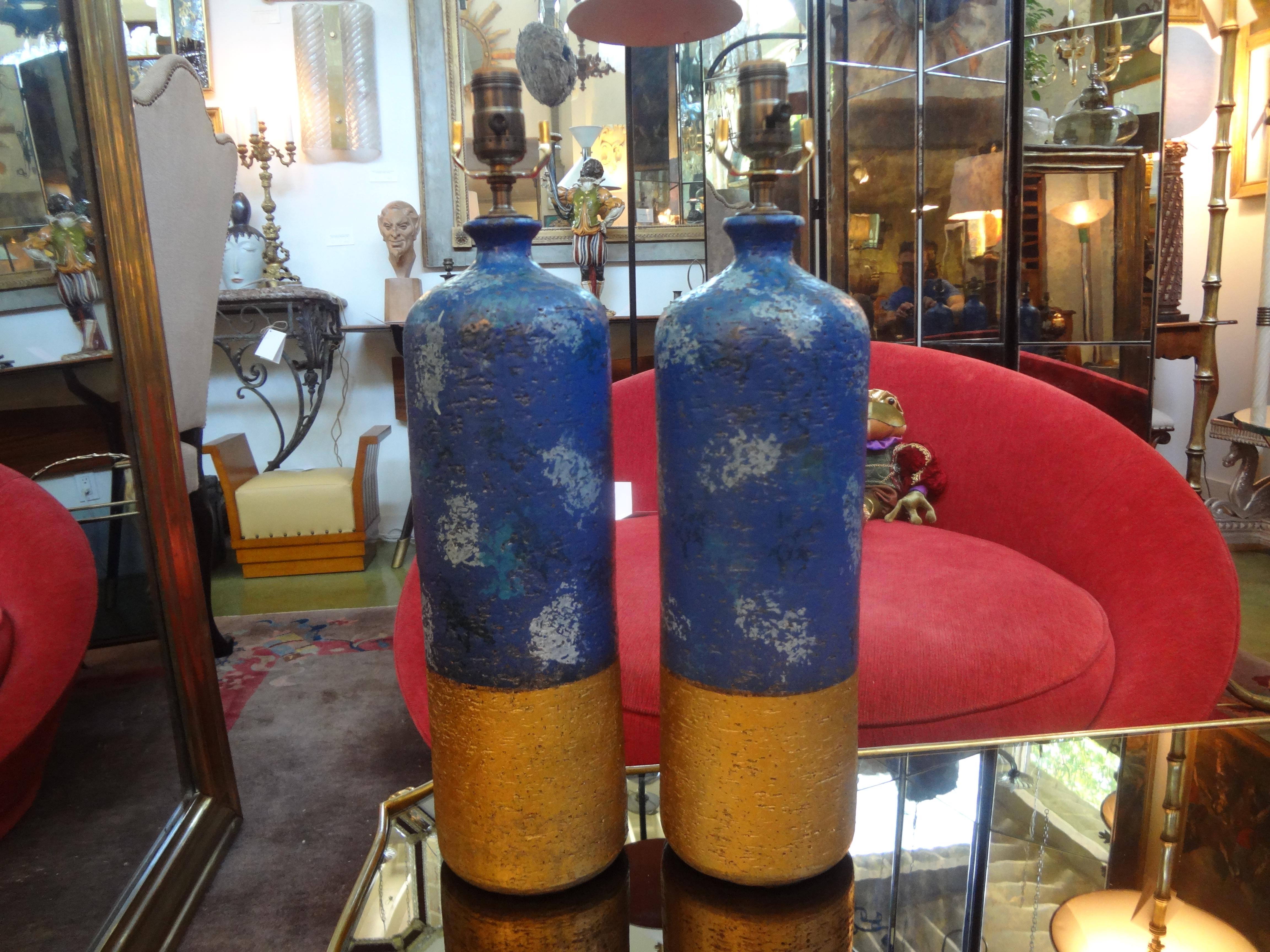 Pair of Italian pottery lamps by Aldo Londi for Bitossi.
Stunning and unusual pair of Italian pottery lamps by Aldo Londi for Bitossi. These masterfully created glazed pottery lamps are in beautiful matte tones of blues and gold and would work well