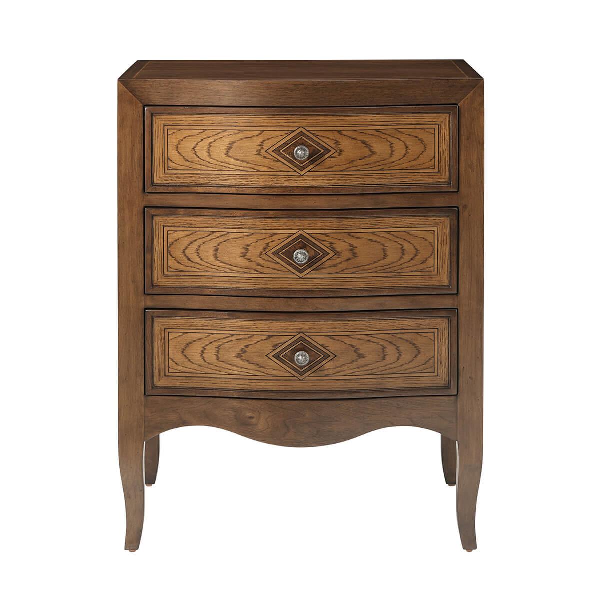 With walnut and oak parquetry with a serpentine form front, three short panel inlaid drawers with antique pewter handles. The nightstands are raised on short cabriole legs.

Dimensions: 24