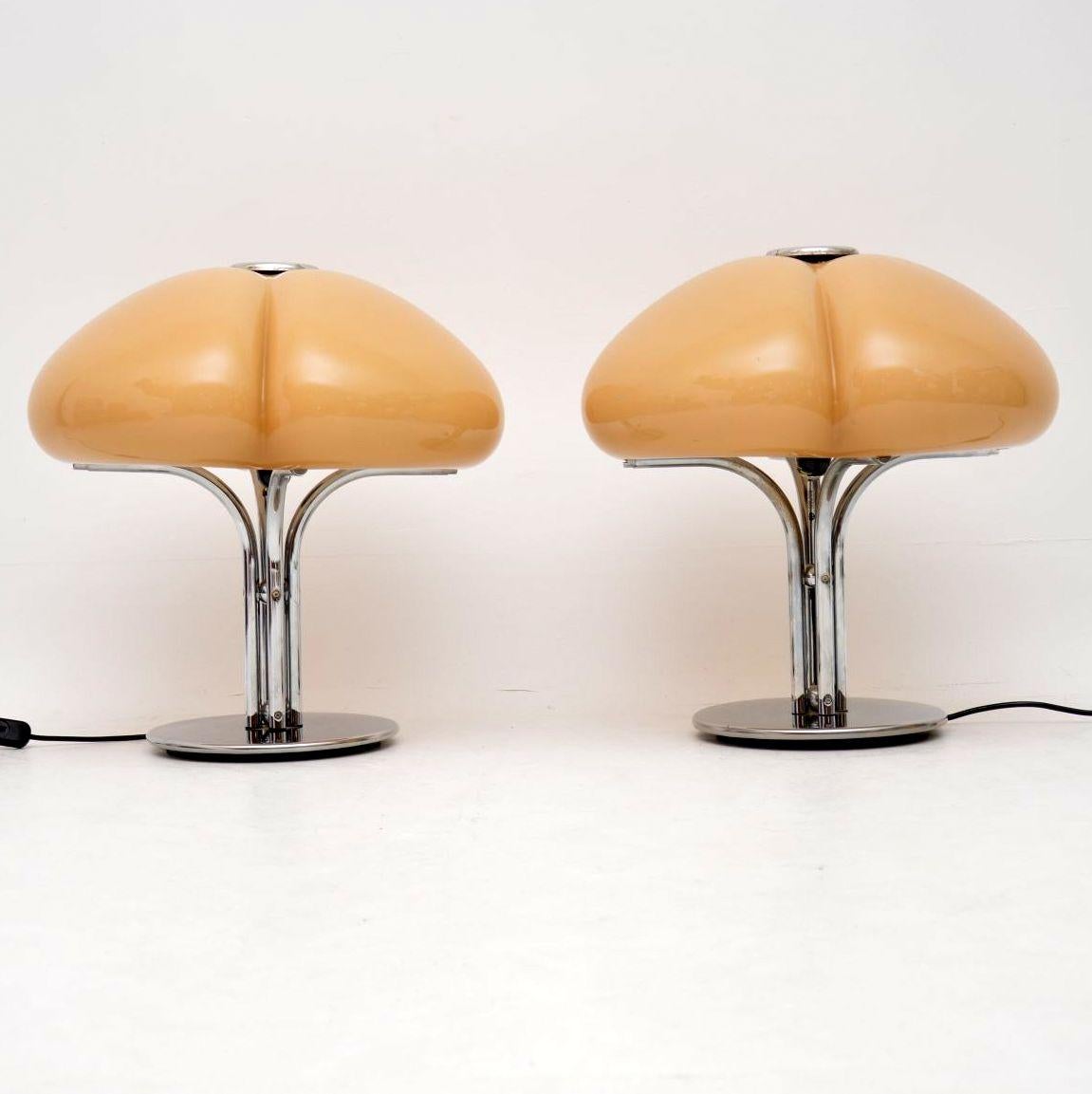 A stunning and very rare pair of vintage 1970s vintage table lamps designed by Gae Aulenti, made by Harvey Guzzini in Italy. This model is called the ‘Quadrifoglio’ lamp, they have lovely curvaceous plastic shades, and chrome bases. These are in