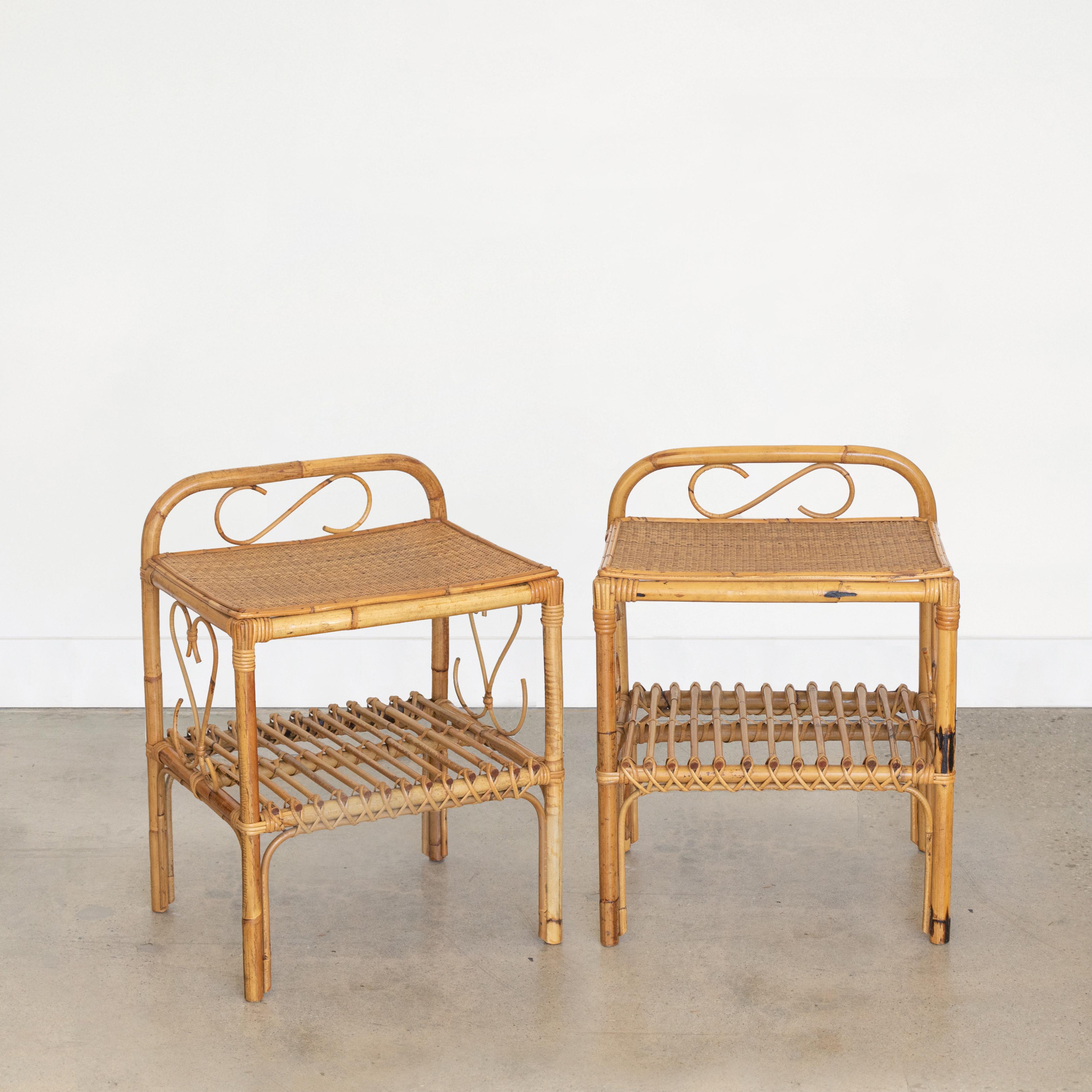 Great pair of Italian rattan bed side tables made in Italy in the 1960's. Original rattan frame with four legs, lower rattan slatted shelf, and top surface covered in woven wicker. Beautiful coiled rattan detail on the sides and back. Table height