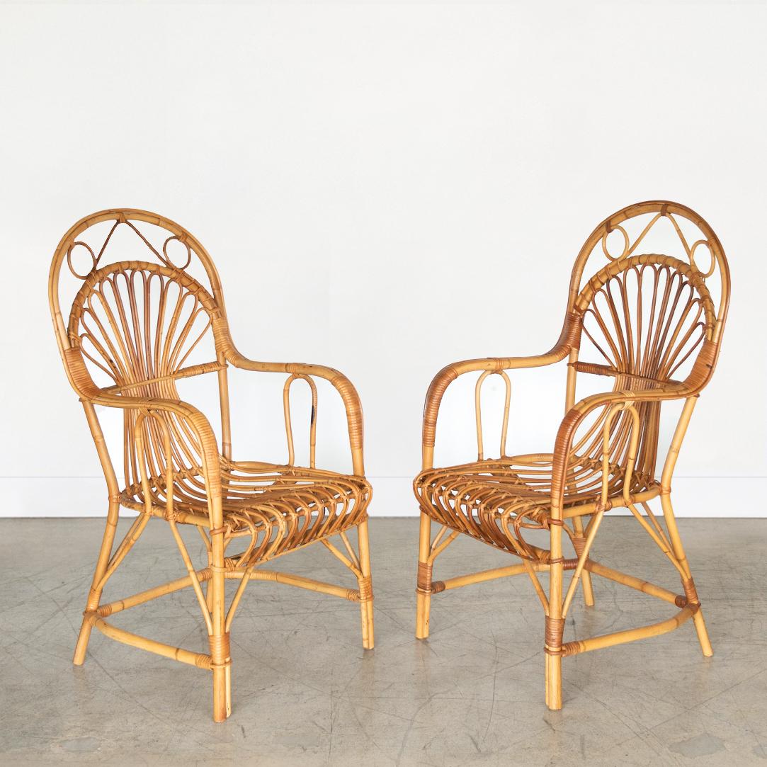 Beautiful pair of rattan armchairs from Italy 1960's. Curved backs and incredible loop detailing. Great vintage condition.