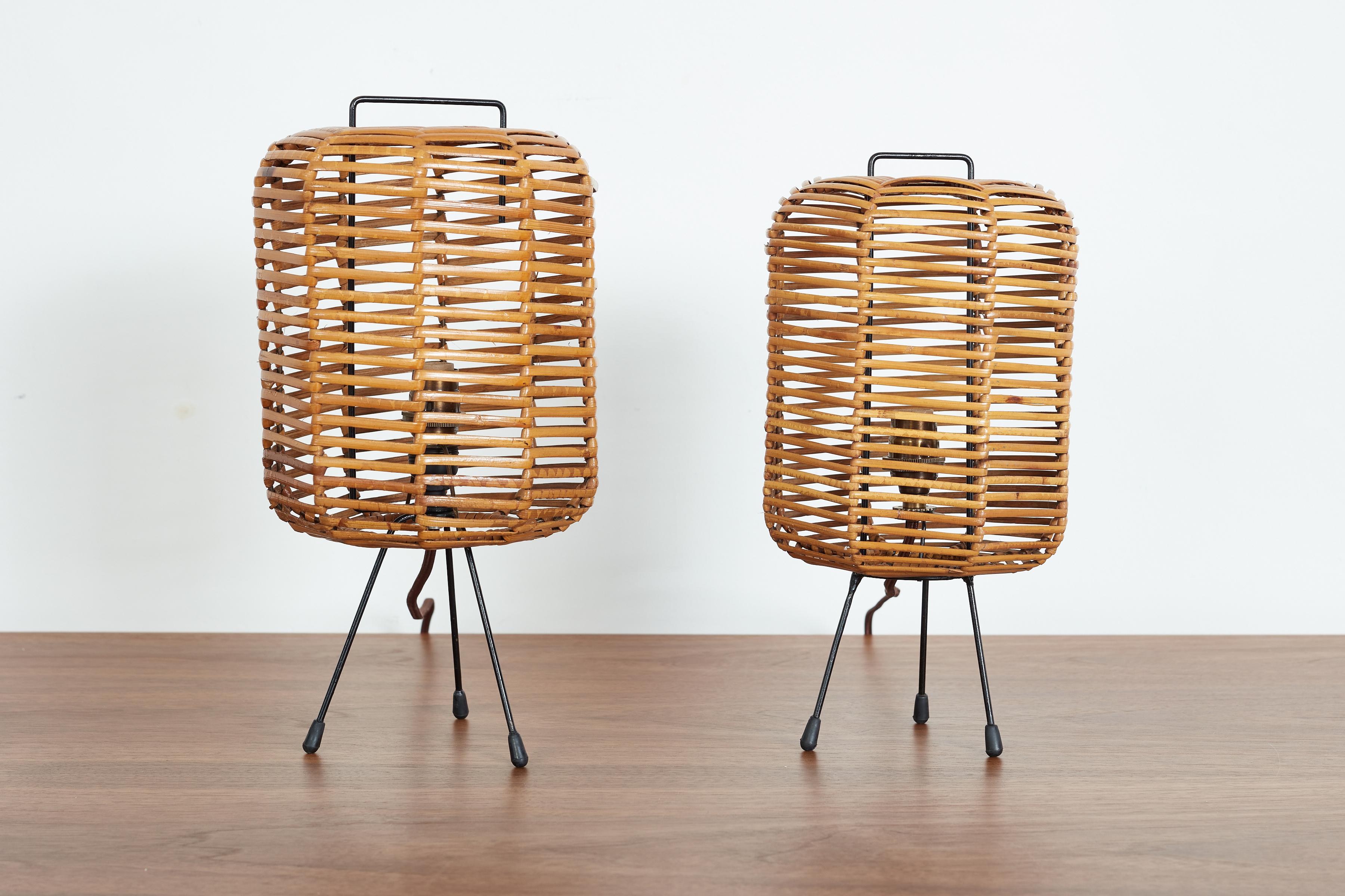 Petite pair of Italian rattan table lamps with iron tripod base. 
Chic pair - sold as a mismatched set. 

Italy circa 1950s. 

1. 12.5