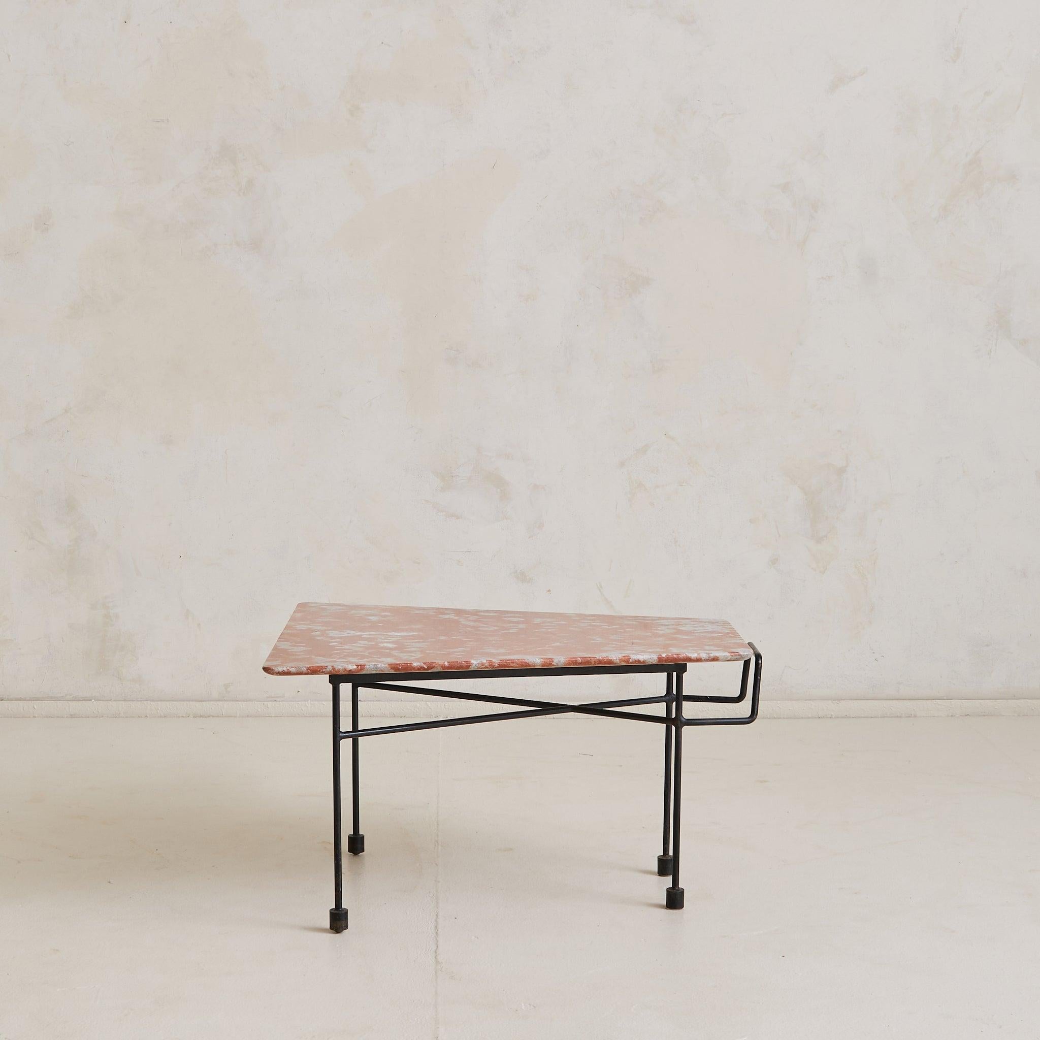 A pair of 1950s Italian coffee tables attributed to Augusto Bozzi. Their asymmetrical surfaces are hand-cut with softly rounded corners and natural veining—each slab unique in tone and composition, with hues of muted red, dove gray, and ivory. The