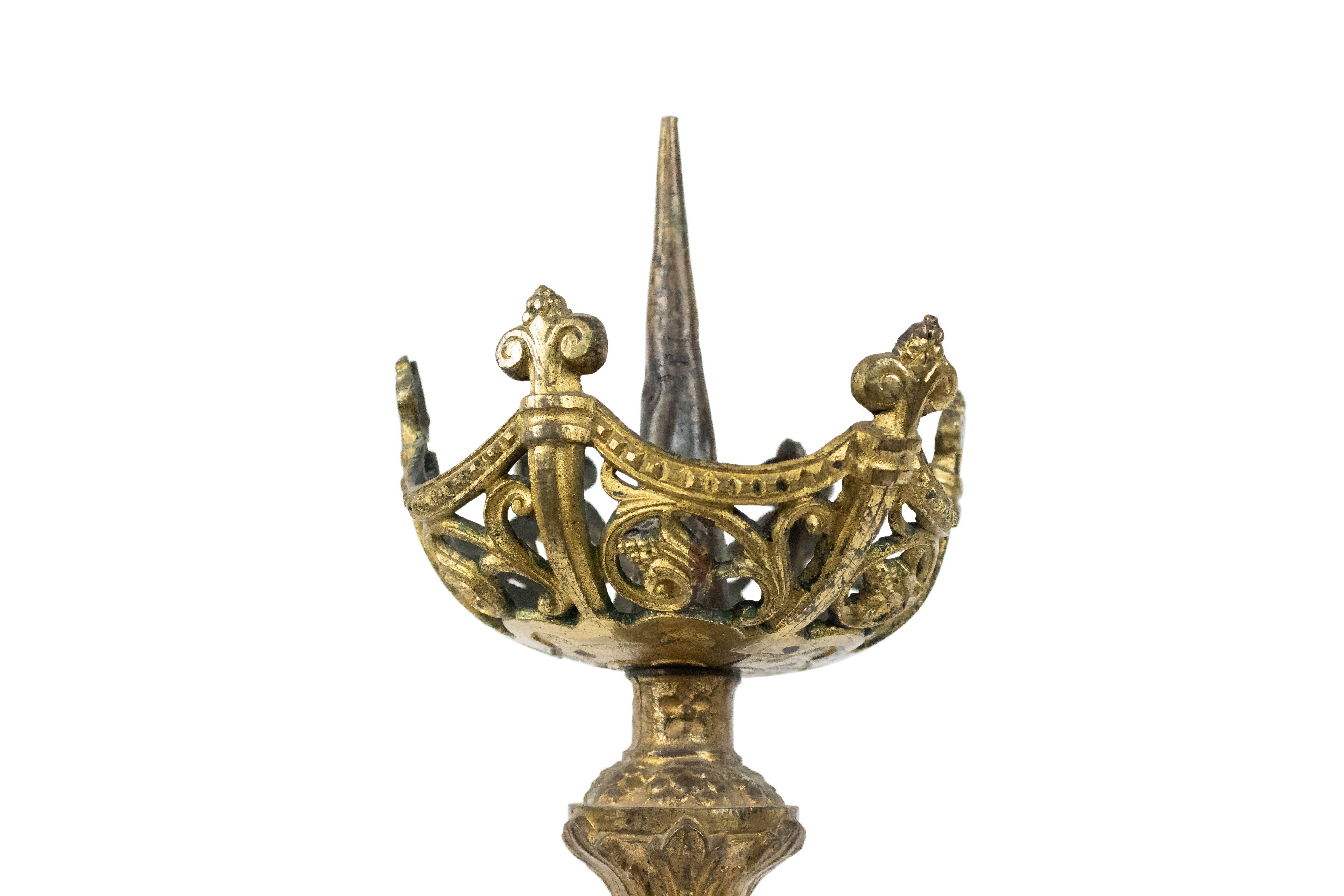 Pair of Italian Renaissance-style (19th Century) bronze altar sticks with swirl top and fluted bottom with round center and scroll filigree base (Priced as pair).
  