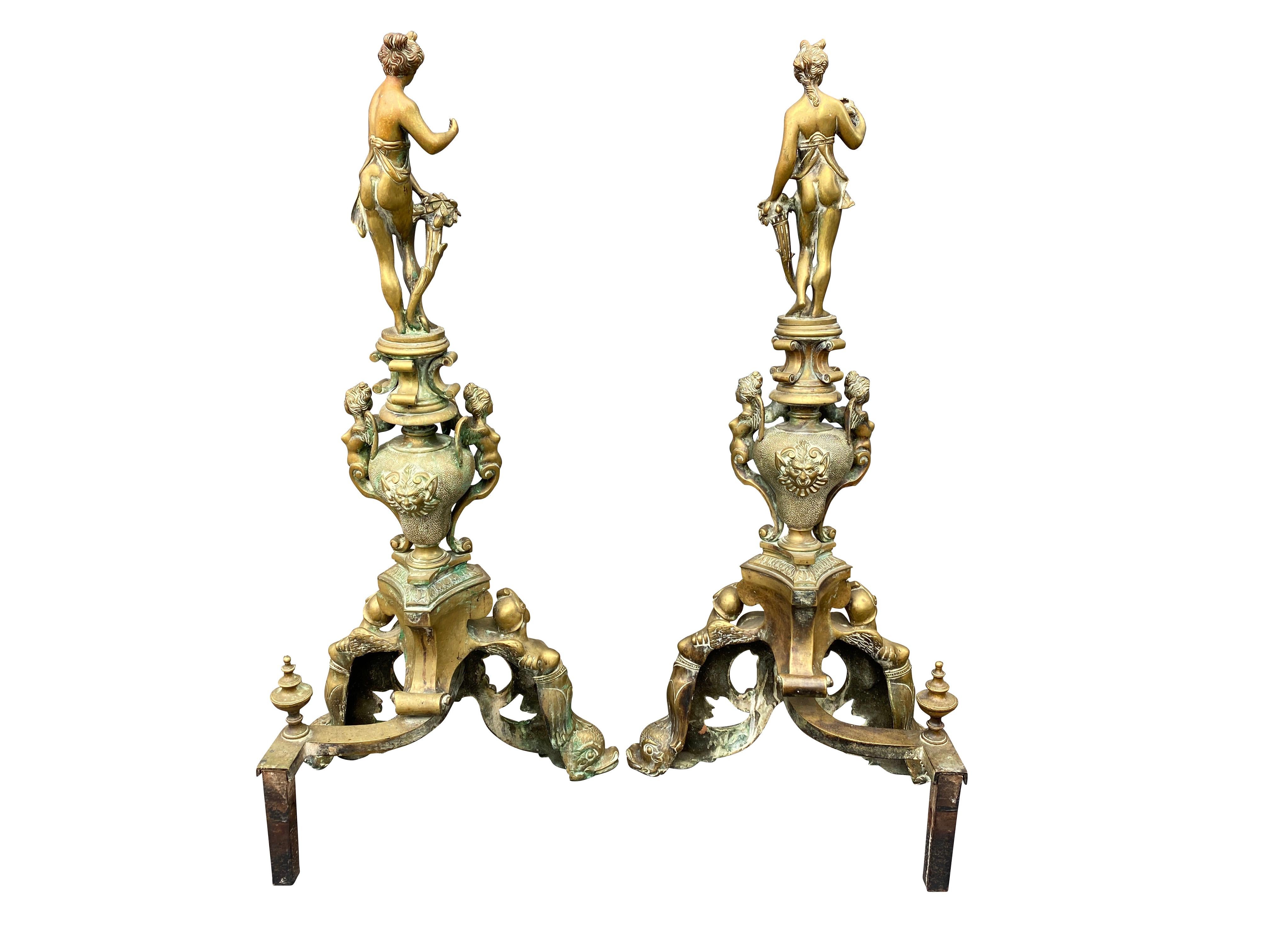 Each with a semi clad maiden finial over various Renaissance motifs on dolphin form supports.