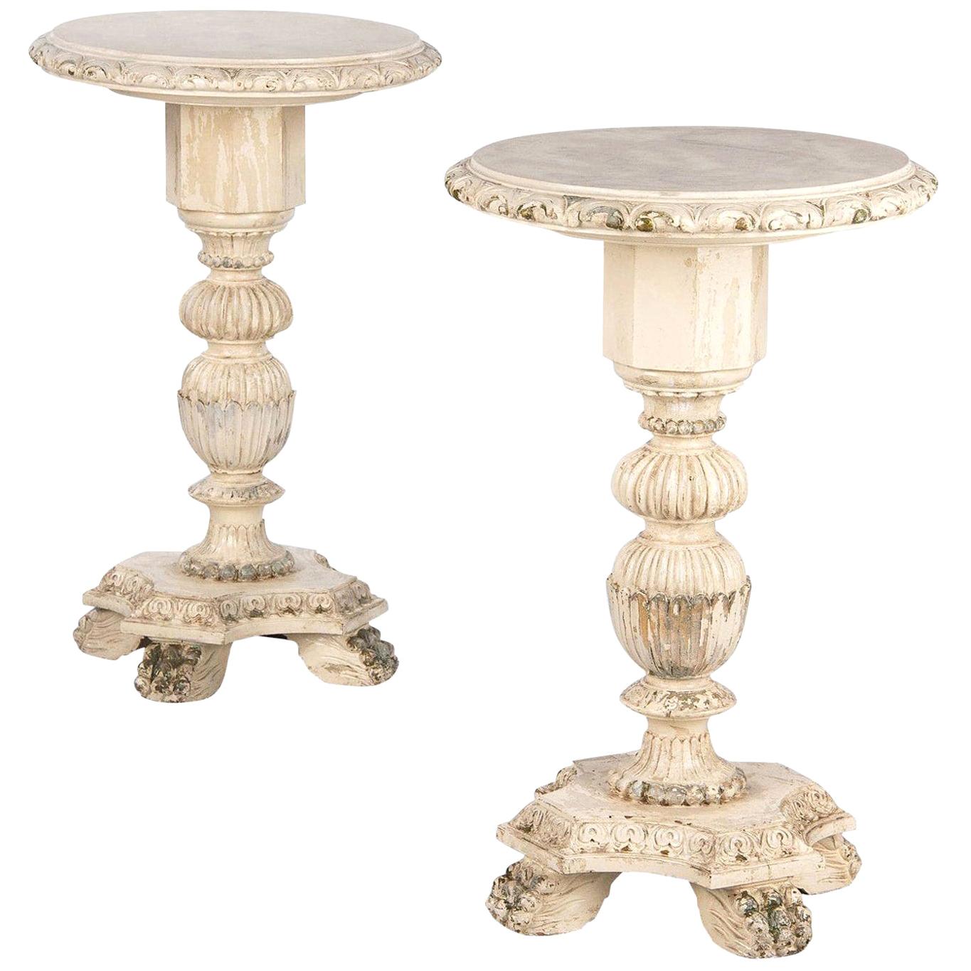 A pair of vintage side table guéridon in the Renaissance Revival style with distressed paint, Italian, circa 1950. Probably beechwood construction with cream colored paint throughout and hits of old gilding and colored paint underneath. Quatrefoil