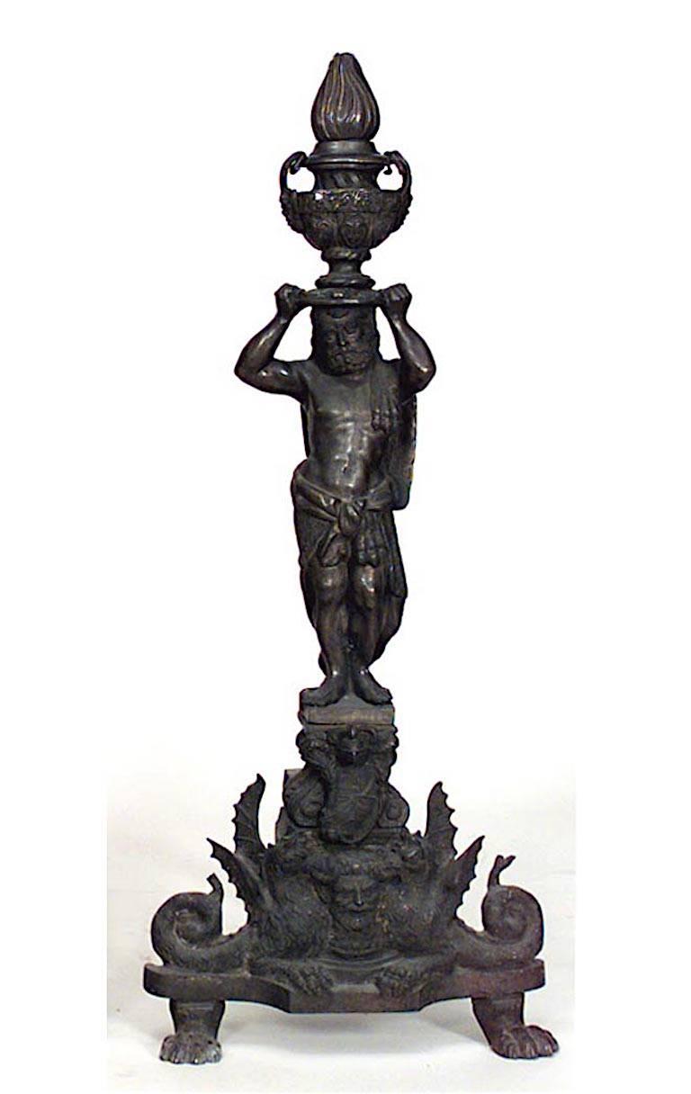 Pair of Italian Renaissance-style (19th Century) bronze andirons with a classical figure holding urn with flame above his head all supported on a double griffin base (PRICED AS Pair)
