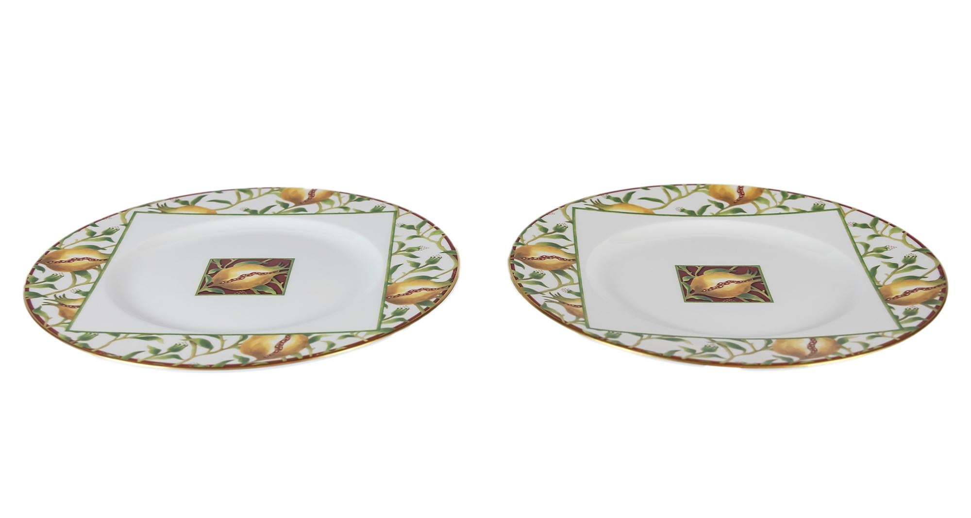Pair of Italian Richard Ginori porcelain plates with pomegranate decor and gilded edge.
  