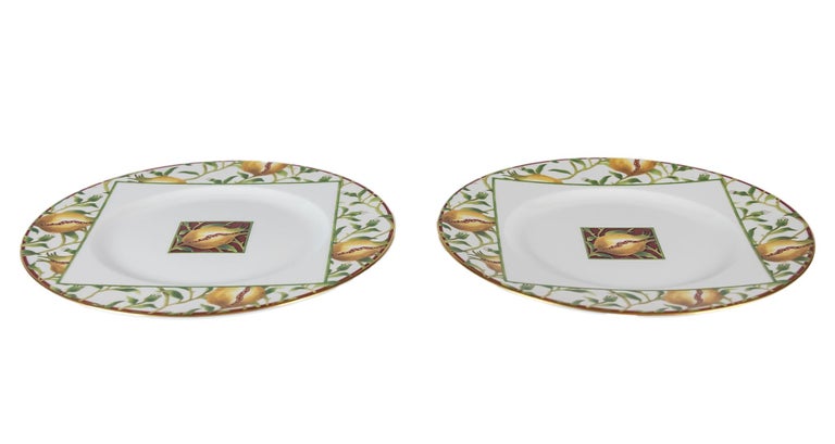 Pair of Italian Richard Ginori porcelain plates with pomegranate decor and gilded edge.
  