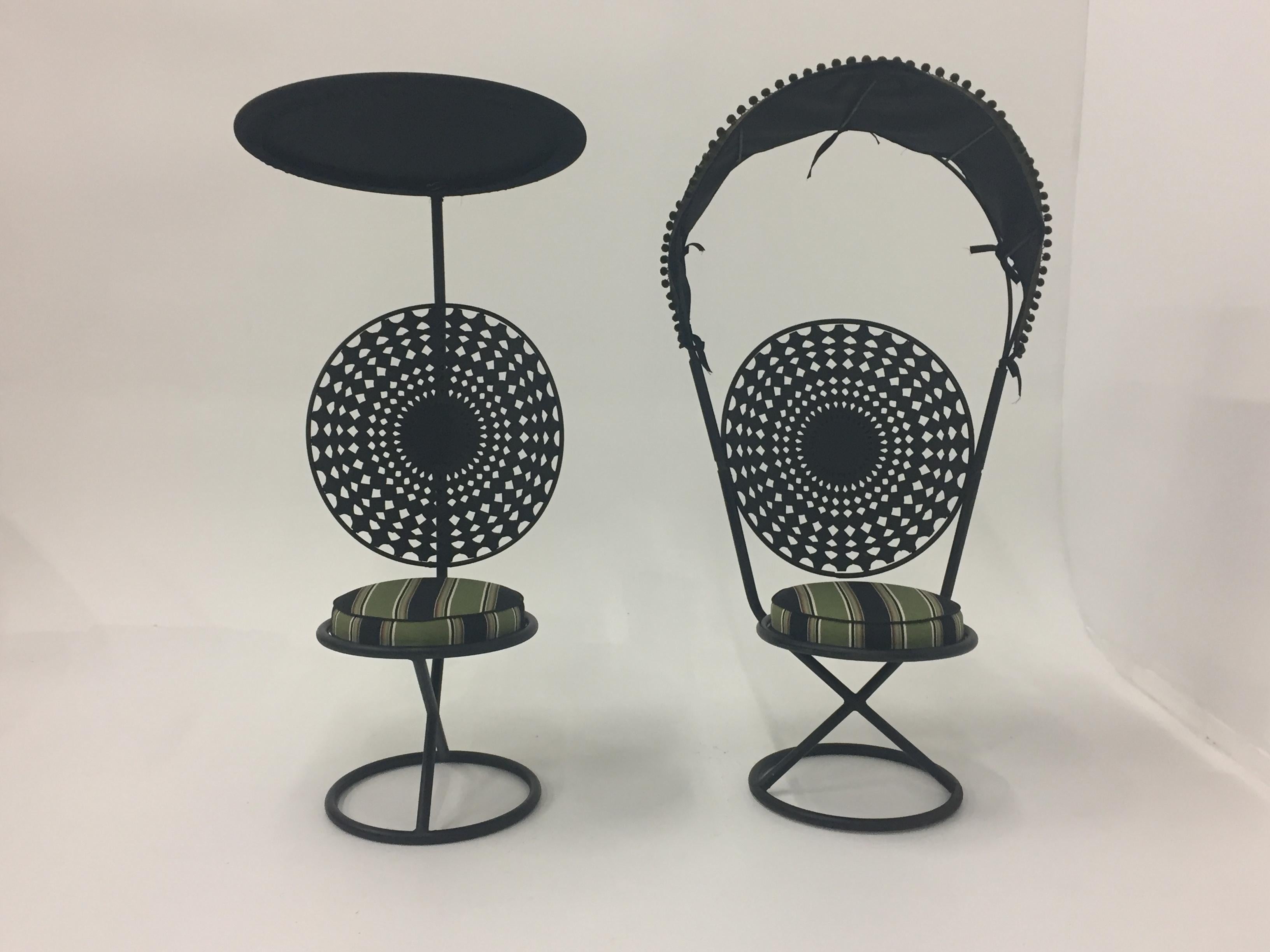 Two super chic fun Mid-Century Modern outdoor chairs made of black enameled steel, recently reupholstered with canvas cushions and canopies, one with a curved pom pom adorned canopy , the other with adjustable canopy that's saucer shaped.

Flat