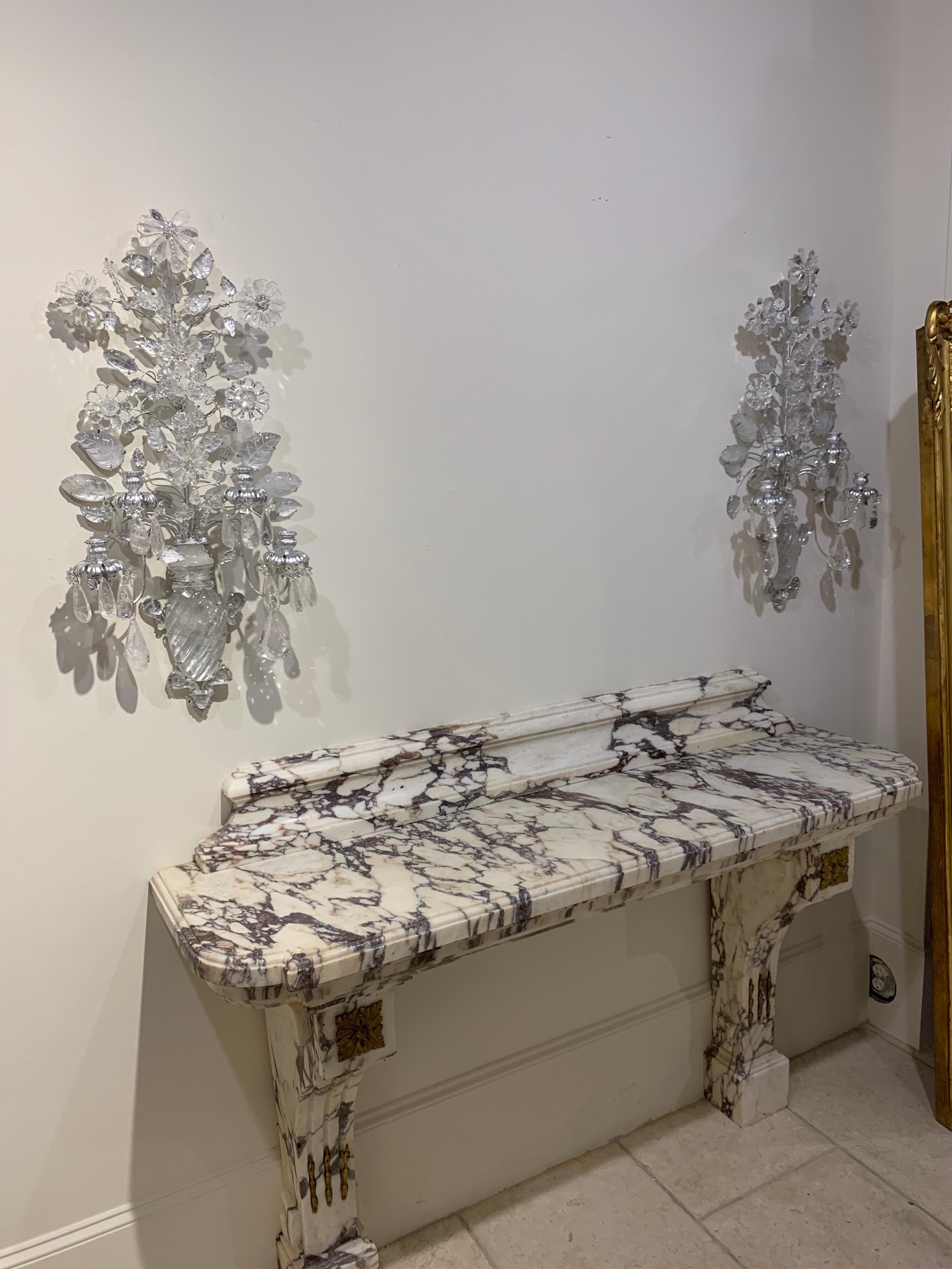 Stylish pair of Italian rock crystal and silver gilt sconces with 4-light. A lovely array of prisms, rock crystals and flowers. Exceptional quality. Gorgeous!