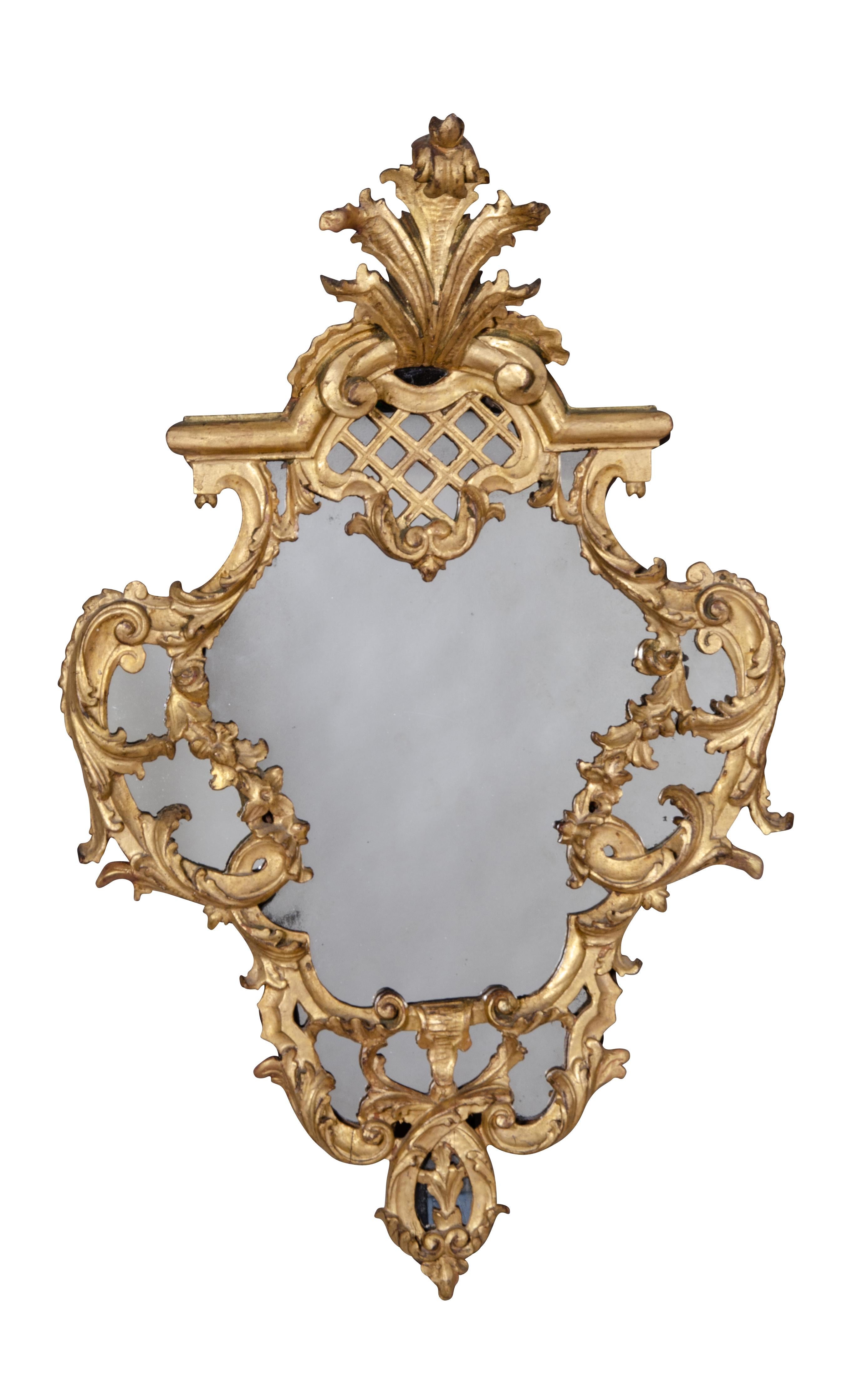 Cartouche shape with leaf crest and mirror palate set in a carved frame with trellis and leaf decoration. Removed from a Bellevue Ave Newport estate occupied by the family for about 100 years.