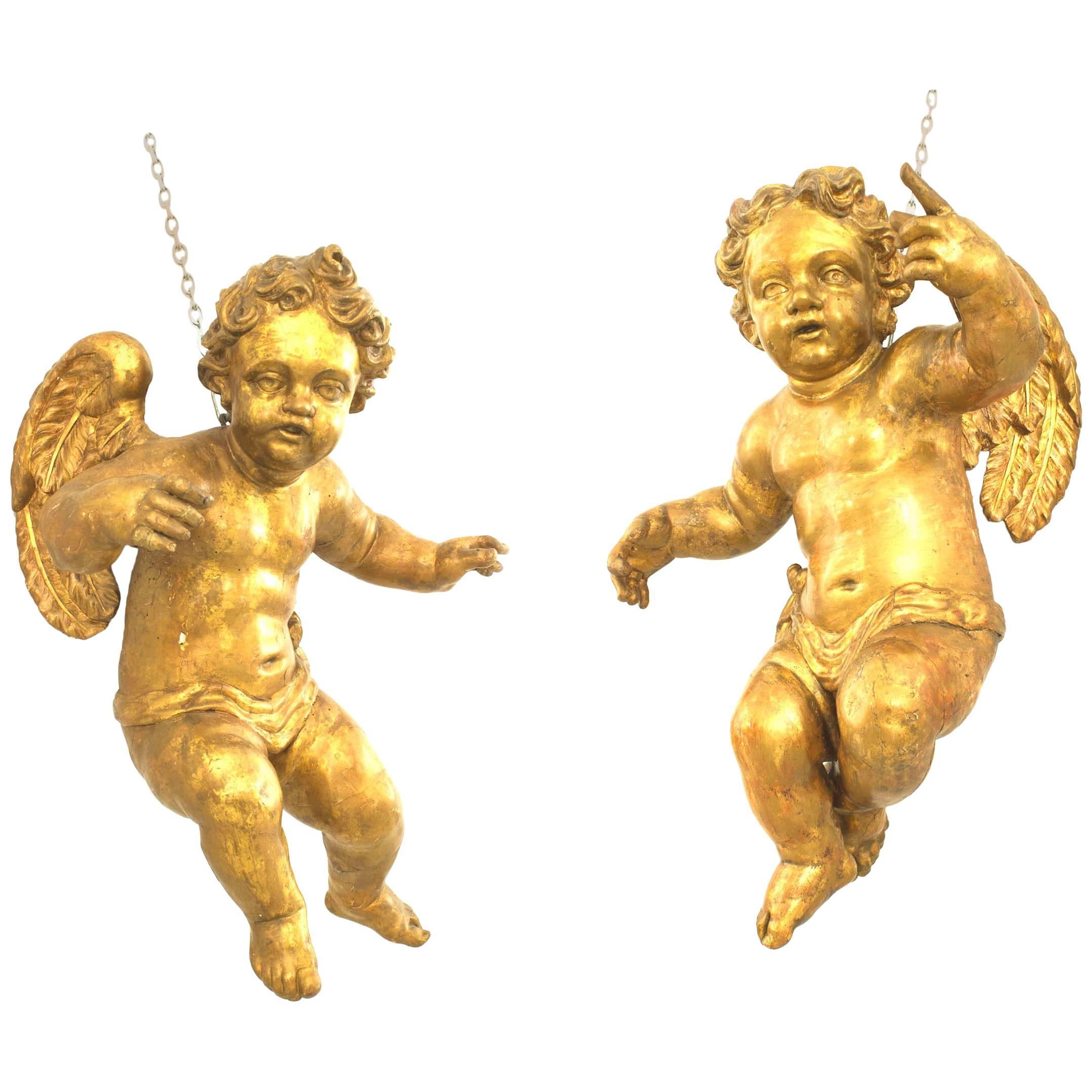 Pair of Italian Rococo Style Life-Size Hanging Cupids For Sale