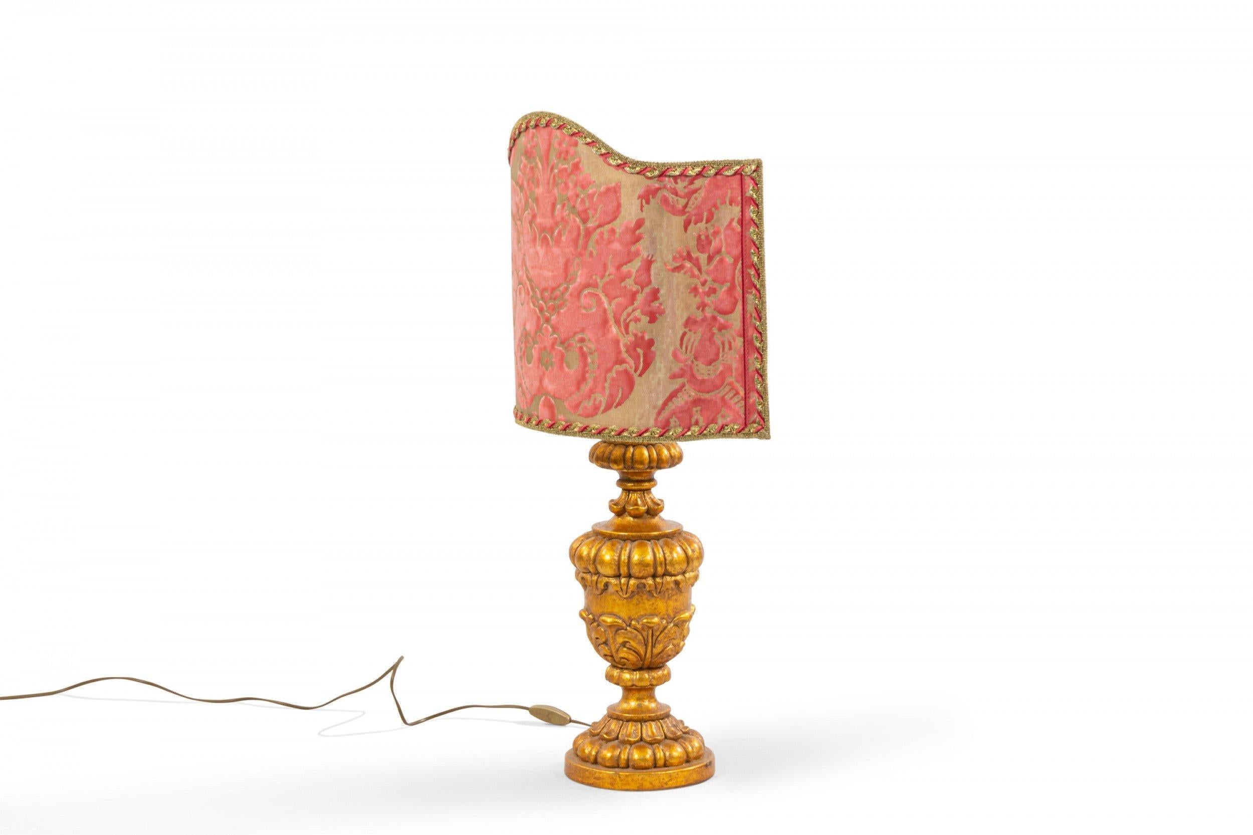Pair of Italian Rococo style (20th Century) gilt carved table lamps with pink & beige quilted damask shaped top half-shades (PRICED AS PAIR).