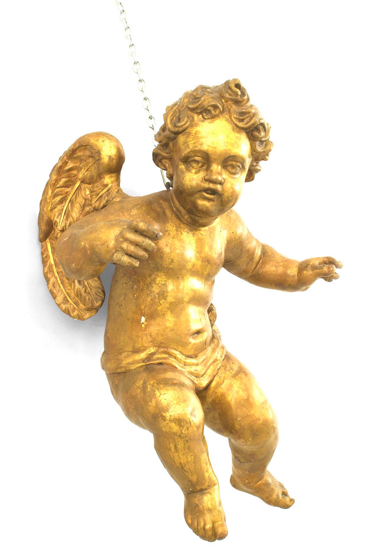 Pair of Italian Rococo style (18th Cent) carved gilt wood winged life size hanging cupid figures.
