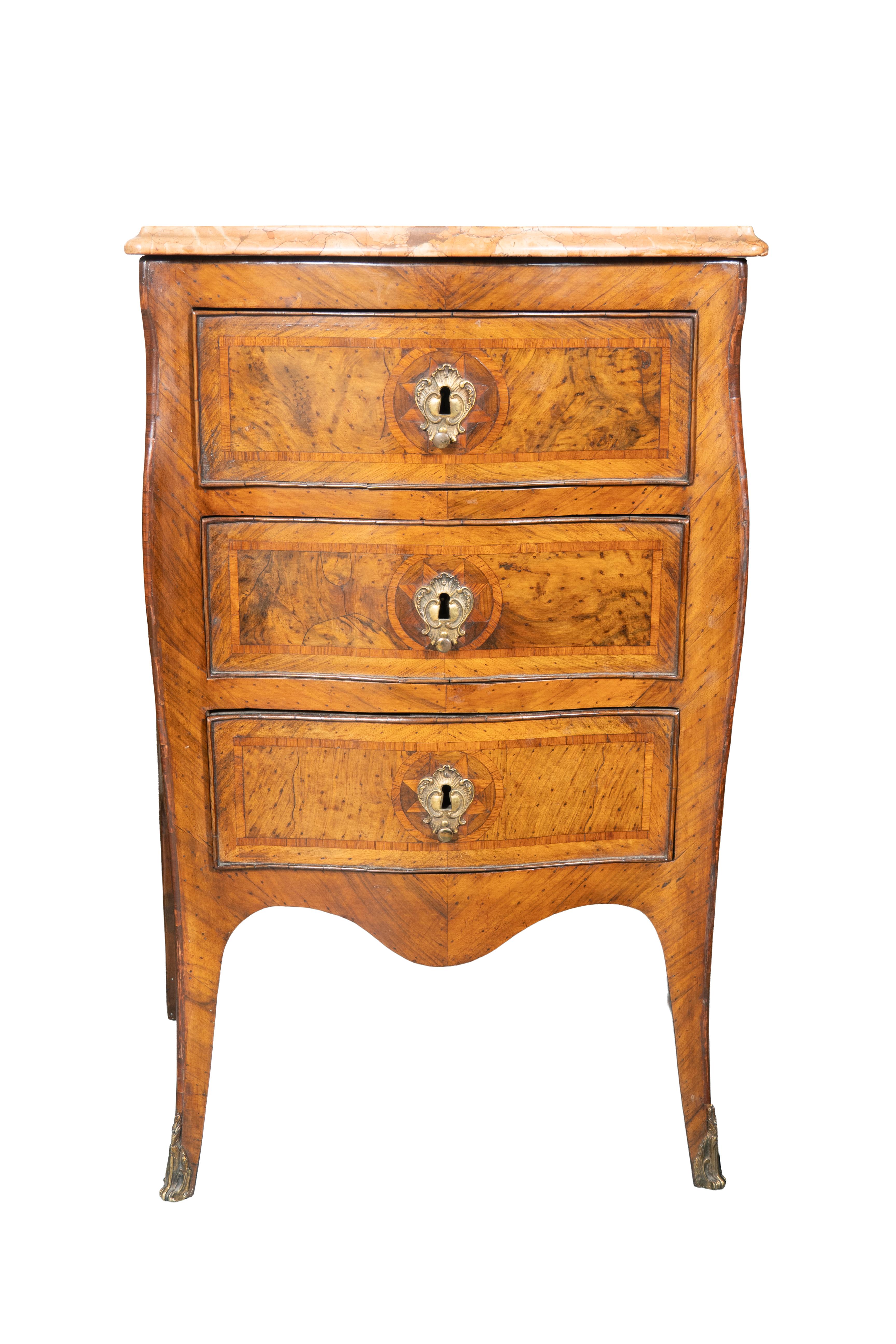 Each with serpentine Verona marble tops over three drawers with escutcheons. Cabriole legs with brass toes. Tops once veneered but now with what appear to be the original tops.