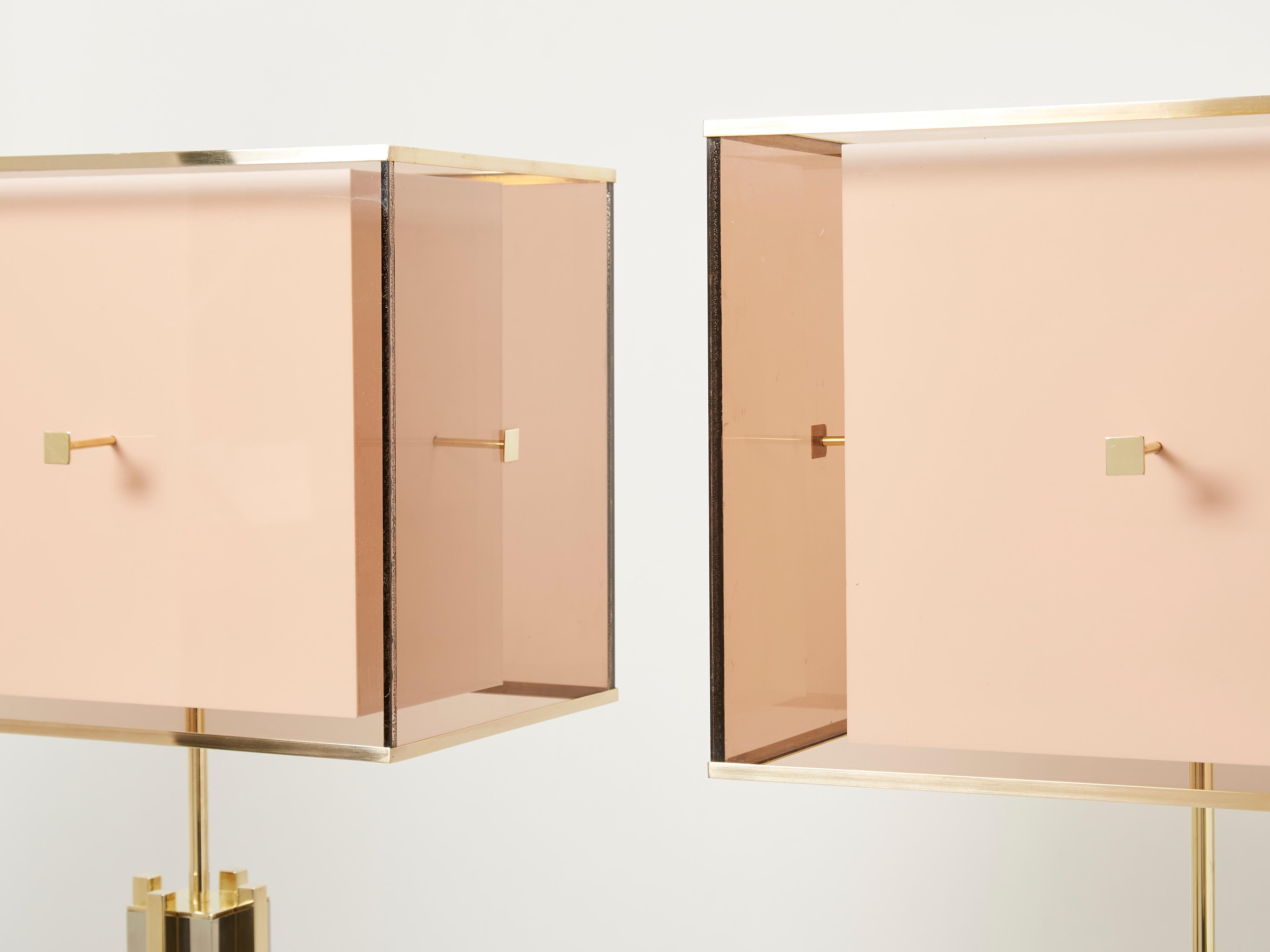 This pair of brass and chrome lamps features a beautiful metal and color combination of brass and chrome, their complementary shades enhanced by the base architectural design. Topped with very nice slightly smoked lucite lampshades, with brass