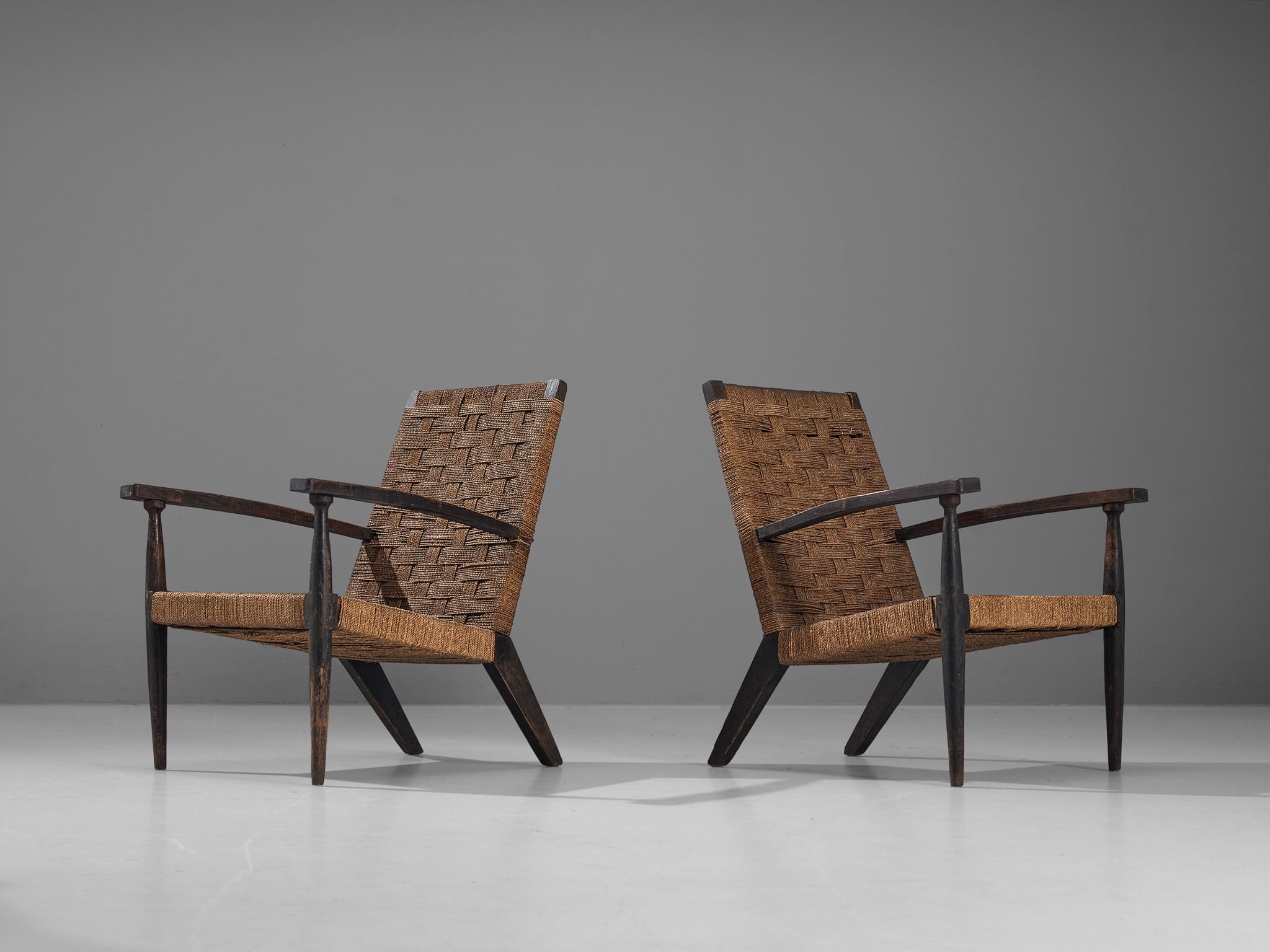 Lounge chairs, stained wood, rope, Italy, 1960s. 

Pair of Italian chairs executed in rope and stained wood. Its design resembles the furniture of Italian designer Giuseppe Pagano Pogatschnig. Rustic yet elegant due the sleek tapered legs that