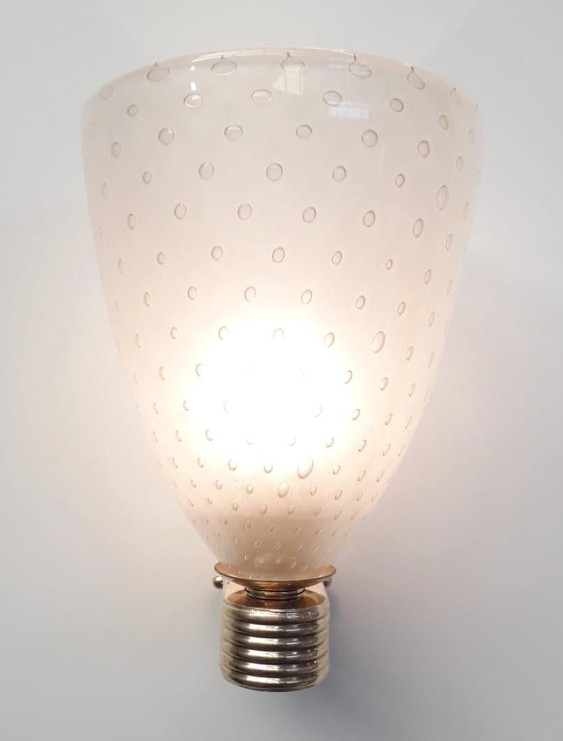 Italian sconces with vintage gold infused frosted Murano glass shade with carefully blown bubbles within the glass using Bollicine technique, mounted on newly made ribbed brass brackets.

Made in Italy.