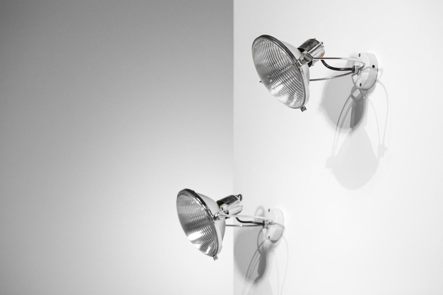Pair of vintage Italian wall lamps from the 60's in the style of Achille Castiglioni's work. Very original wall lamps by their design and their very modern look for the time. Chromed metal structure, adjustable lampshade and composed of a