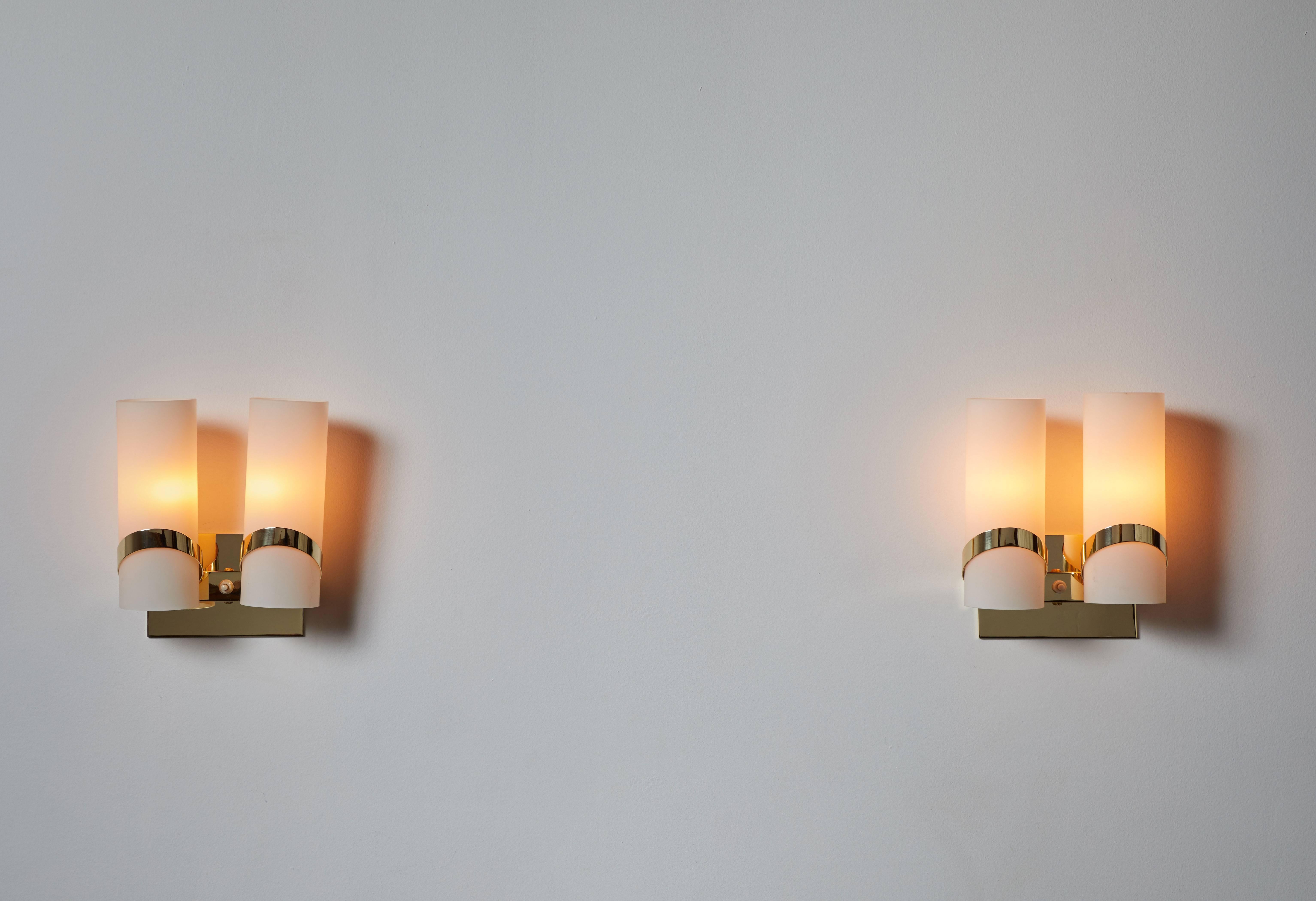 Pair of sconces designed in Italy, circa 1960s. Brass and brushed satin glass. Wired for US junction boxes. Each light takes one E27 100w maximum bulb. Brass has been fully restored and polished.