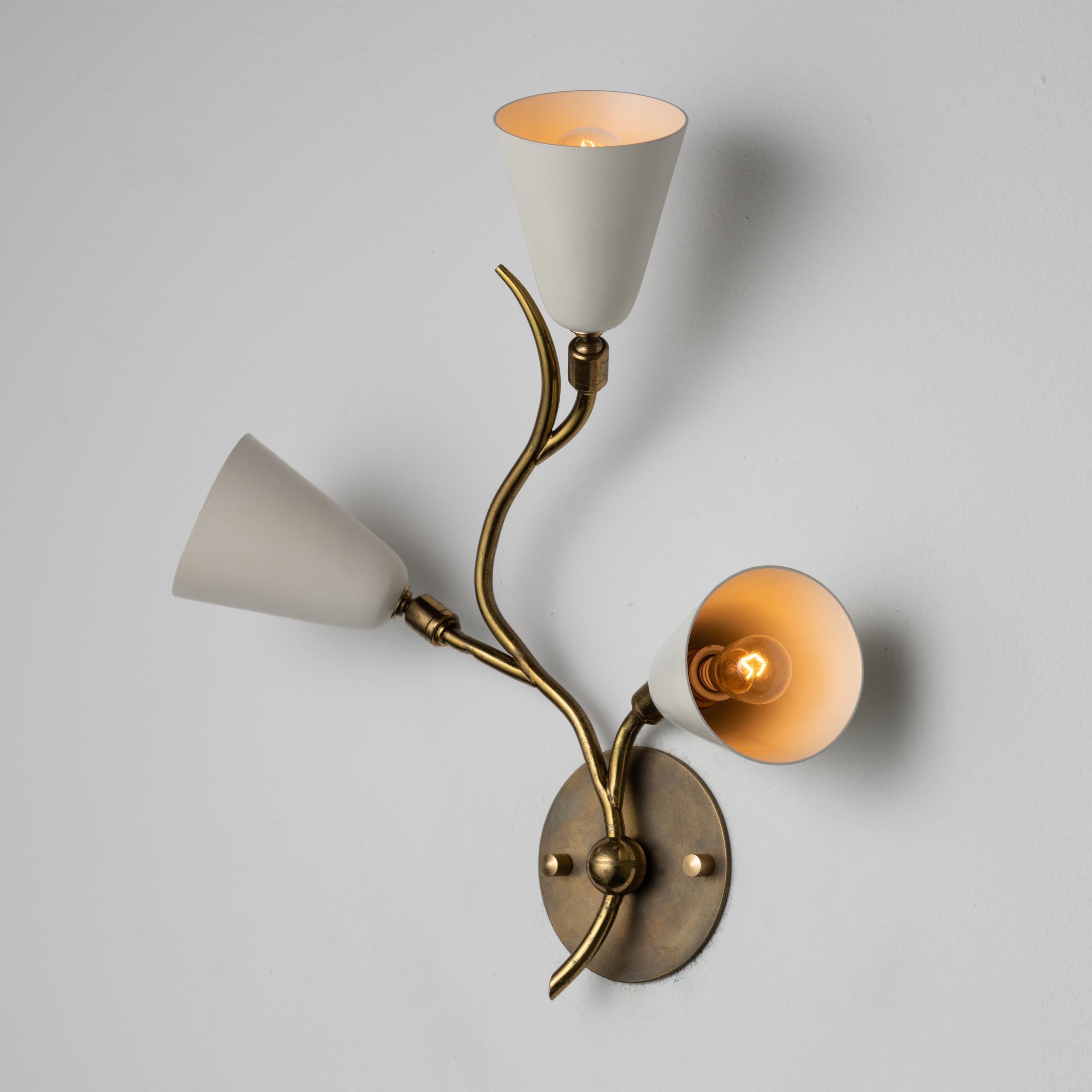 Pair of Italian sconces. Designed and manufactured in Italy, circa the 1950s. Three tulip-shaped sconces sit on branch-like stems. The shades pivot slightly on ball joints, allowing for illuminating positioning. Holds three E12 sockets, adapted for
