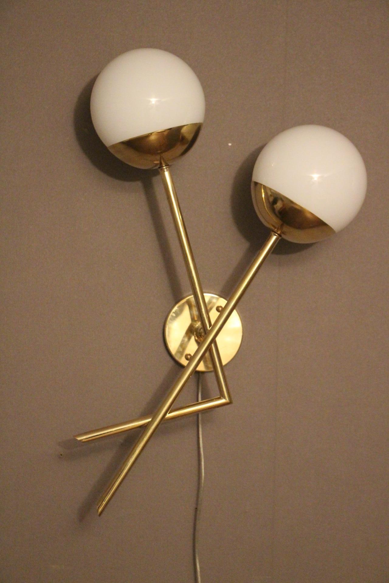 This pair of sconces features brass structure and 2 white Murano glass globes. It is very simple and very elegant at the same time.
It could be showcased in every distinctive interiors.
Its shape is very unusual and could match with design or mid