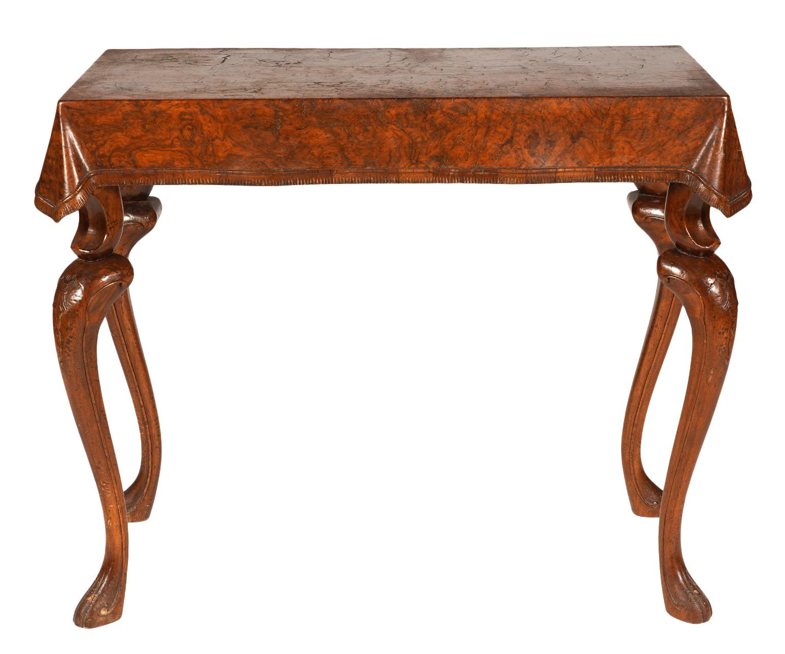 Uniquely carved with a draped table cloth and two step cabriole legs on paw feet these console tables offers a rare to find artistic quality. You can feel the life like carving of the table cloth, even the small undulations along the edge. The style