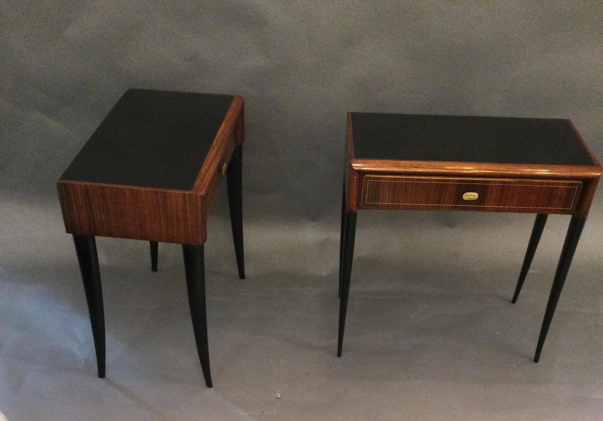 An elegant pair of hand crafted side tables. Drawers with brass handles, fantastic marquetry made of walnut, 
black glass top and ebonized legs.
Attributed to Gio Ponti.