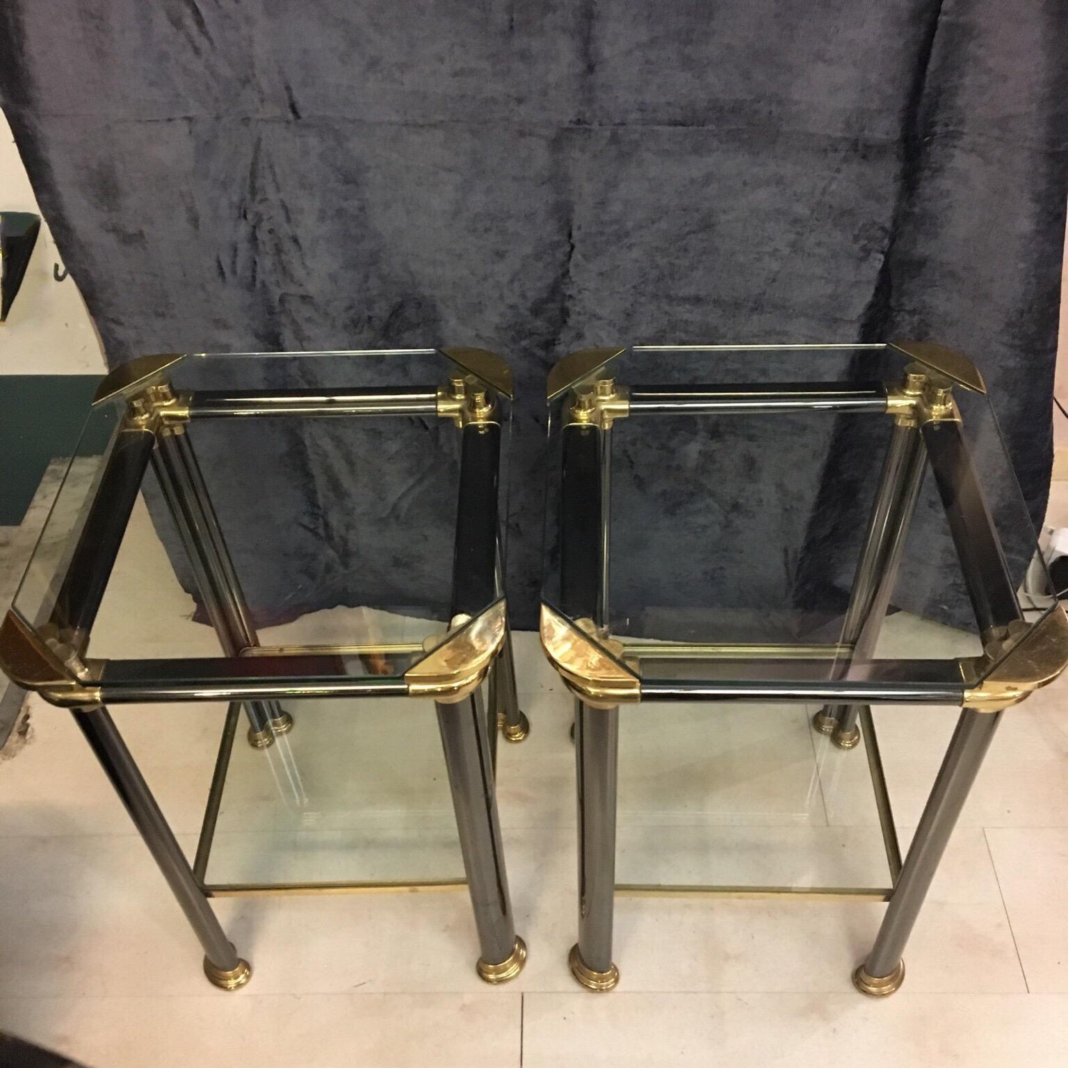 Pair of Italian design side tables with anthracite metal and brass structure, two crystal shelves, signed by Mara, Italy. They are heavy and solid in perfect vintage condition. Please note that the brass is original of the period and thus shows