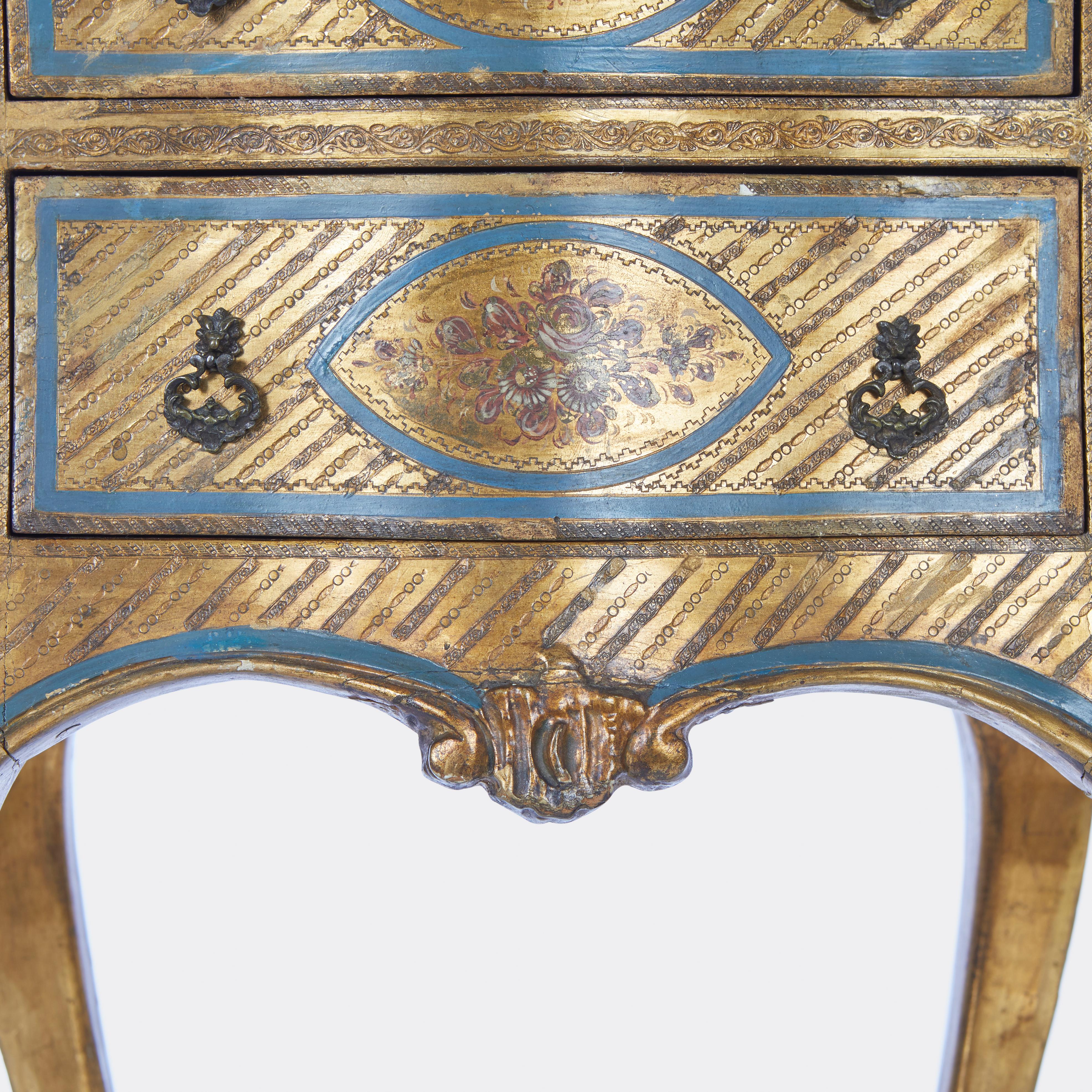 Pair of Italian side tables with 3 drawers having cabriole legs and bombe front, back and side, having incised decoration overall with gilt and blue painted finish. Circa 1930.

Measures: 15.5''W x 14.5''D x 32''H, 11''W x 10''D at the top.