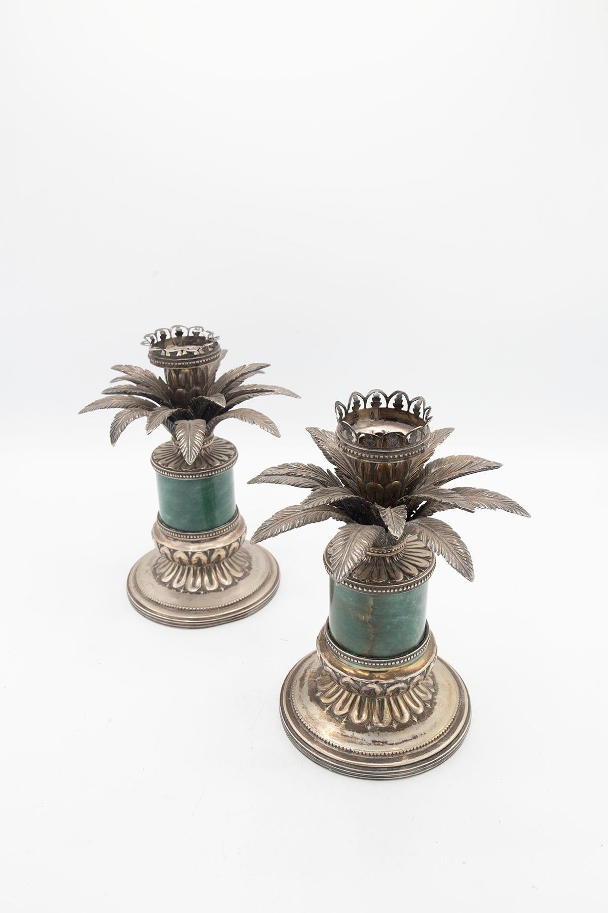 Elegant pair of candle holders of Italian manufacture from the 1960s-1970s. Made with finely hand-chiseled silver frame, where two distinguished elements are screwed together. At the base we find a round saucer with ornate patterned ornaments. While