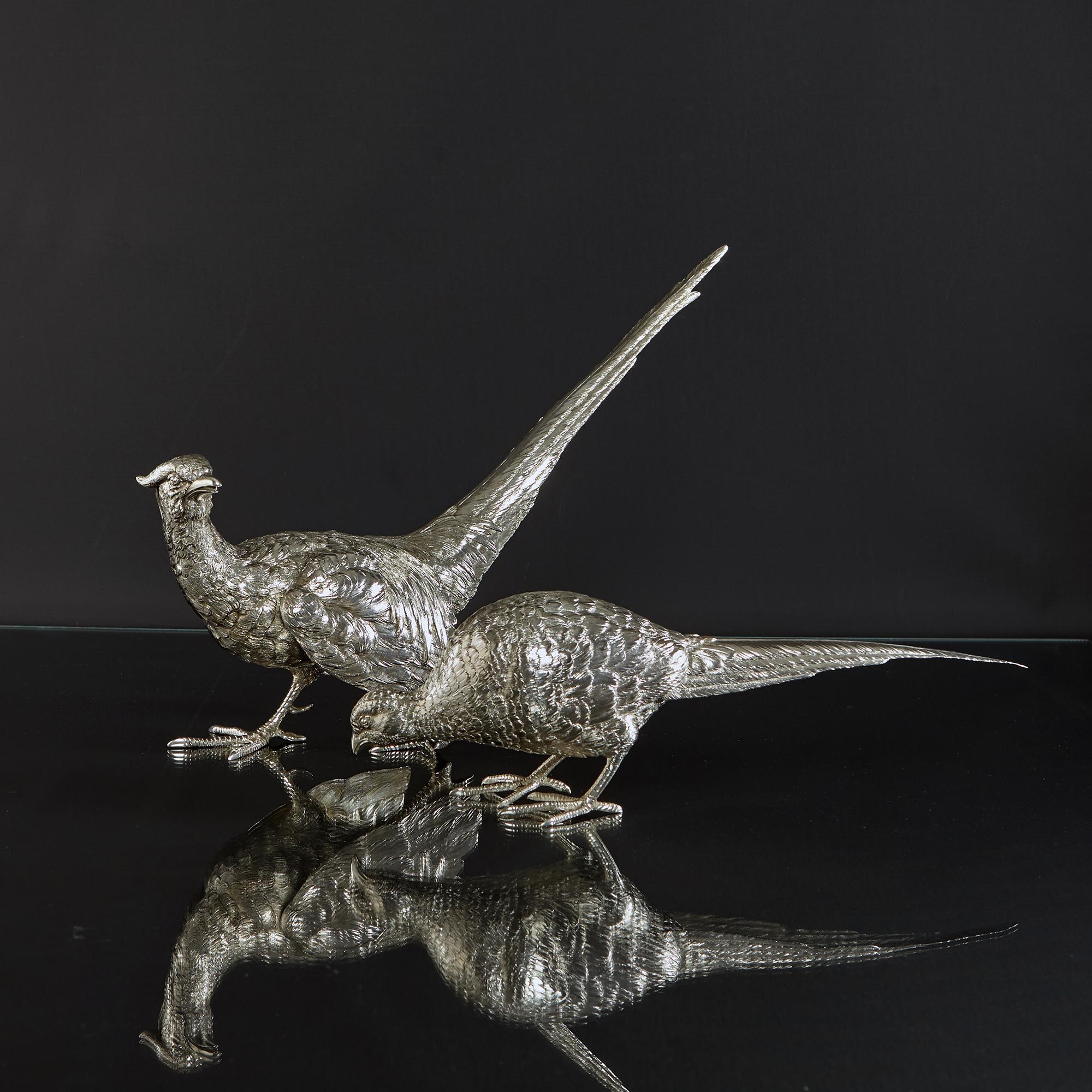 Pair of finely detailed model pheasants in 800 standard silver made in Italy circa 1950 and in excellent condition. Each silver pheasant is cast and hand-chased to give a lively and lifelike appearance standing in a courting pose. The male silver