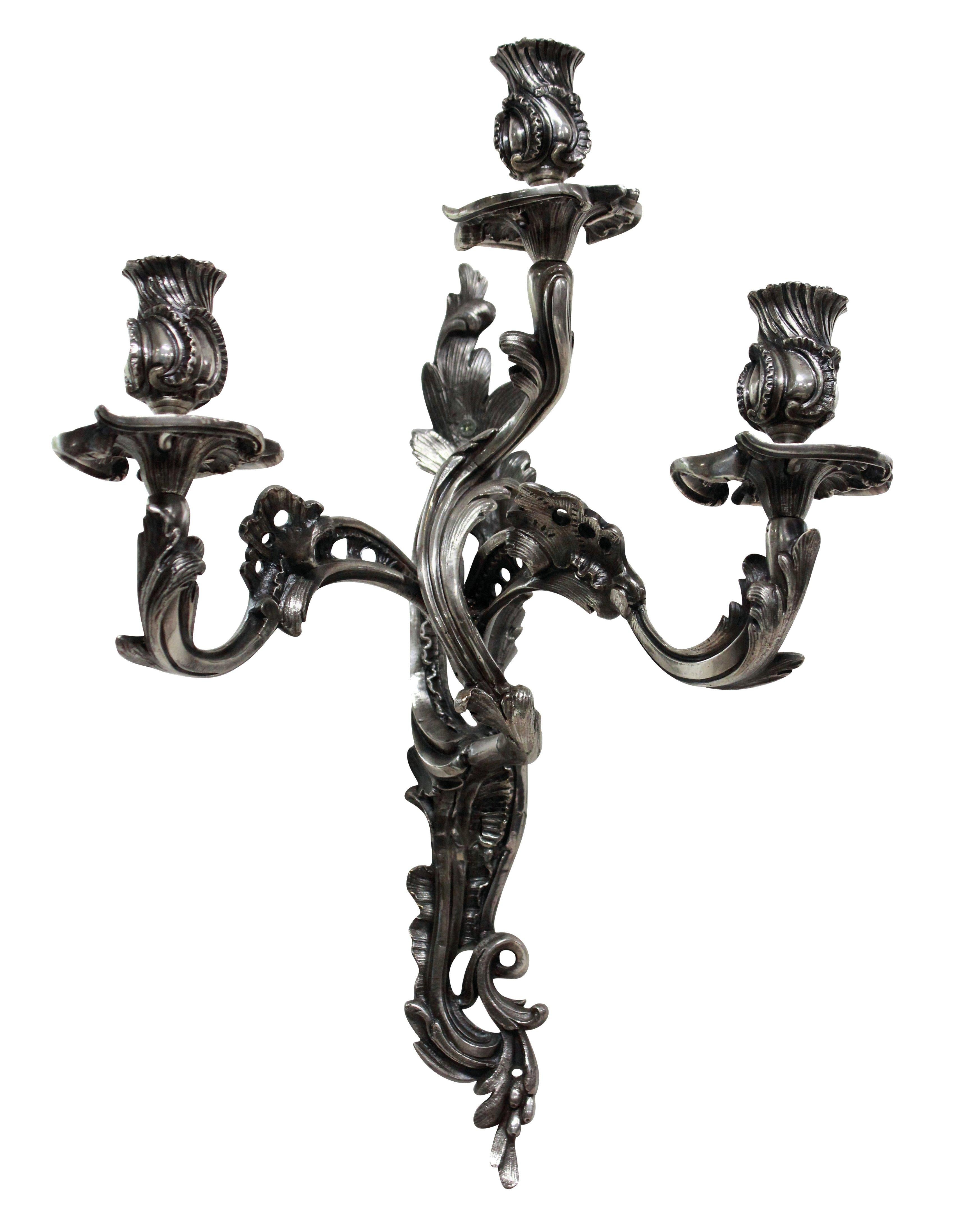 A pair of late 19th century Italian silver plated bronze Rococo three-arm wall sconces.

