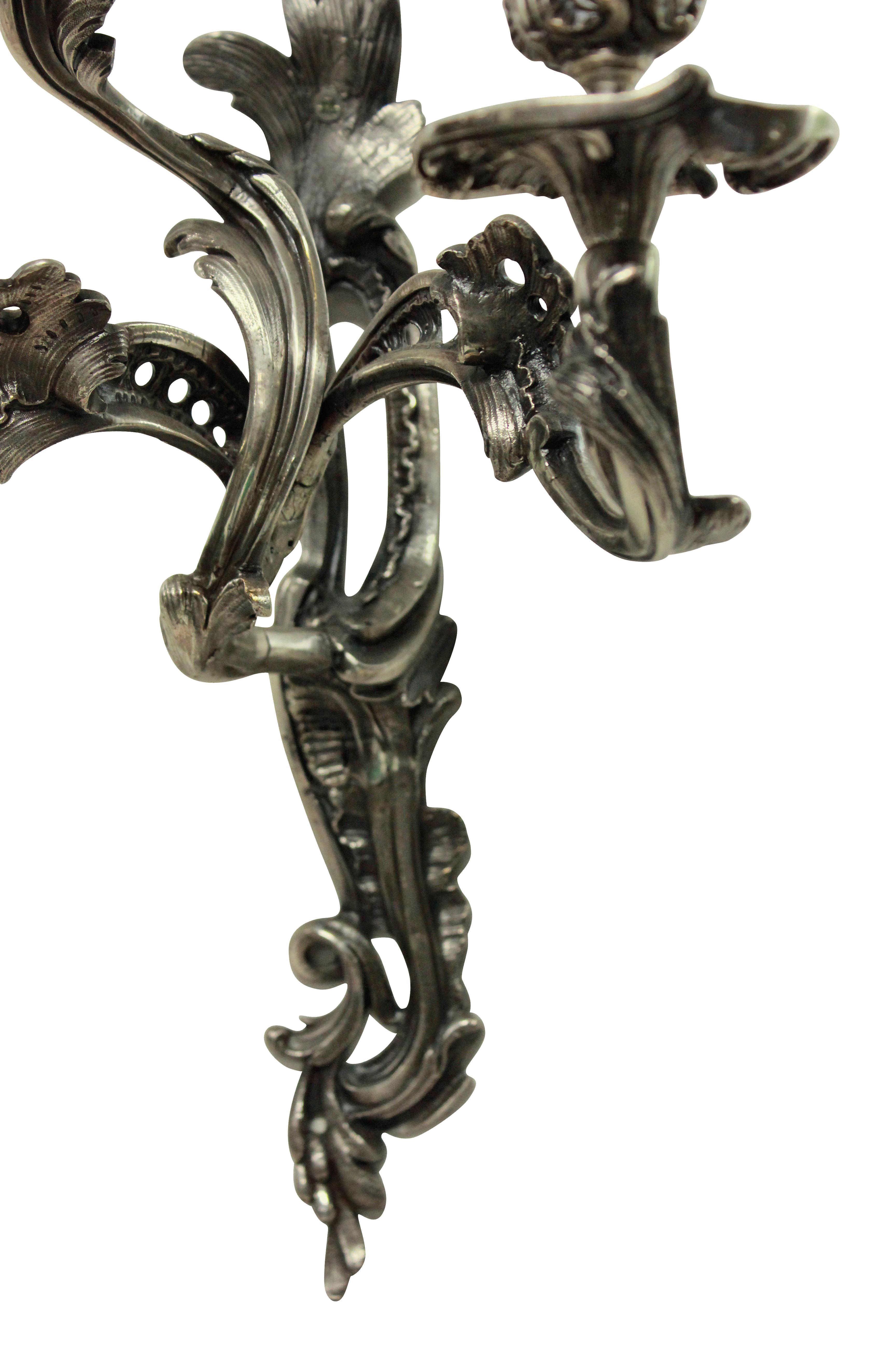 A pair of late 19th century Italian silver plated bronze Rococo three-arm wall sconces.

