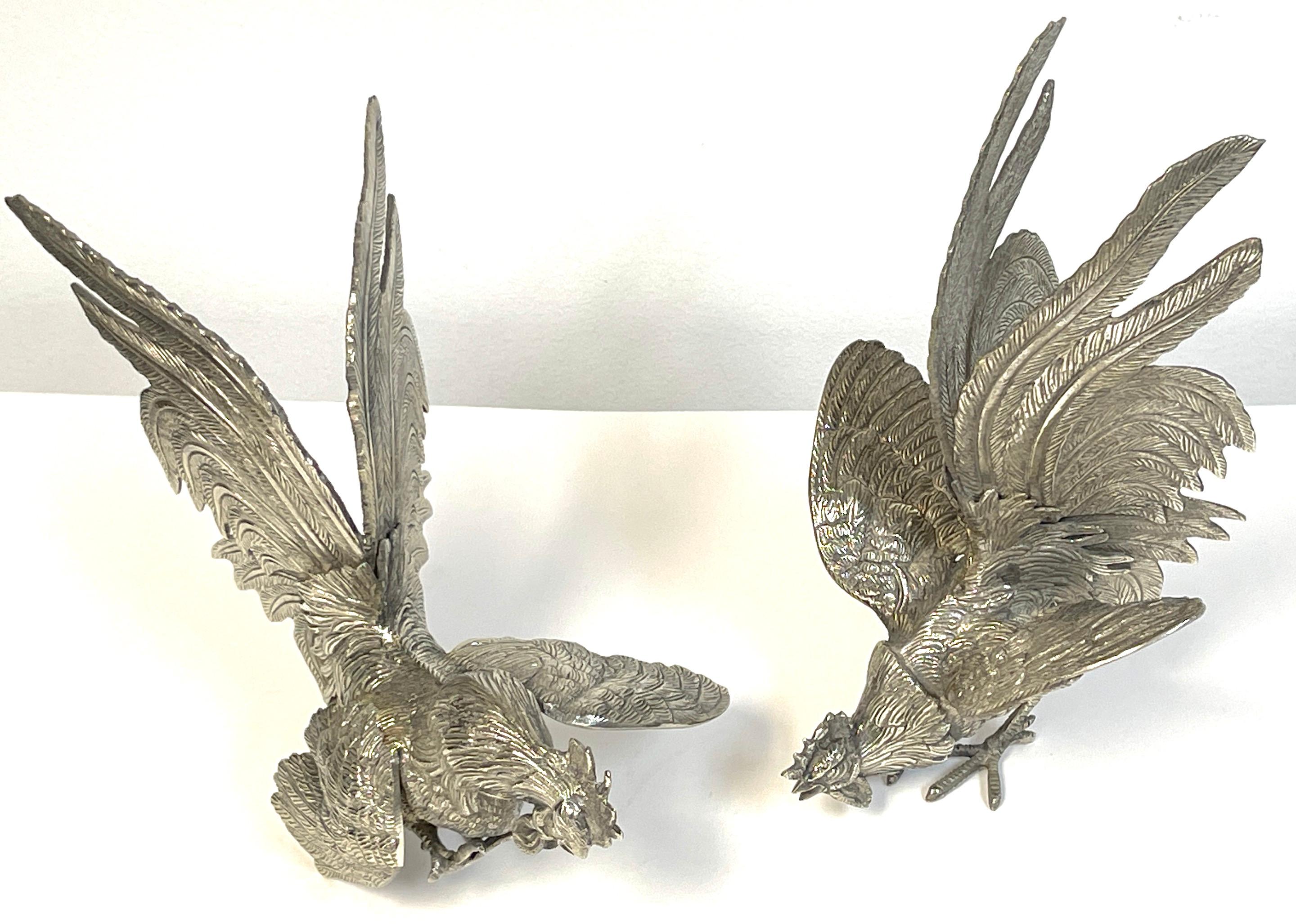 Pair of Italian Silverplated Rooster Table Ornaments 'Fighting Roosters' 
Italy, circa 1960s

Each one a silver-plated model of a rooster, realistically cast and modeled.

Overall Measurements 
Rooster #1 -10-Inches high h x 7 -Inches wide x 7