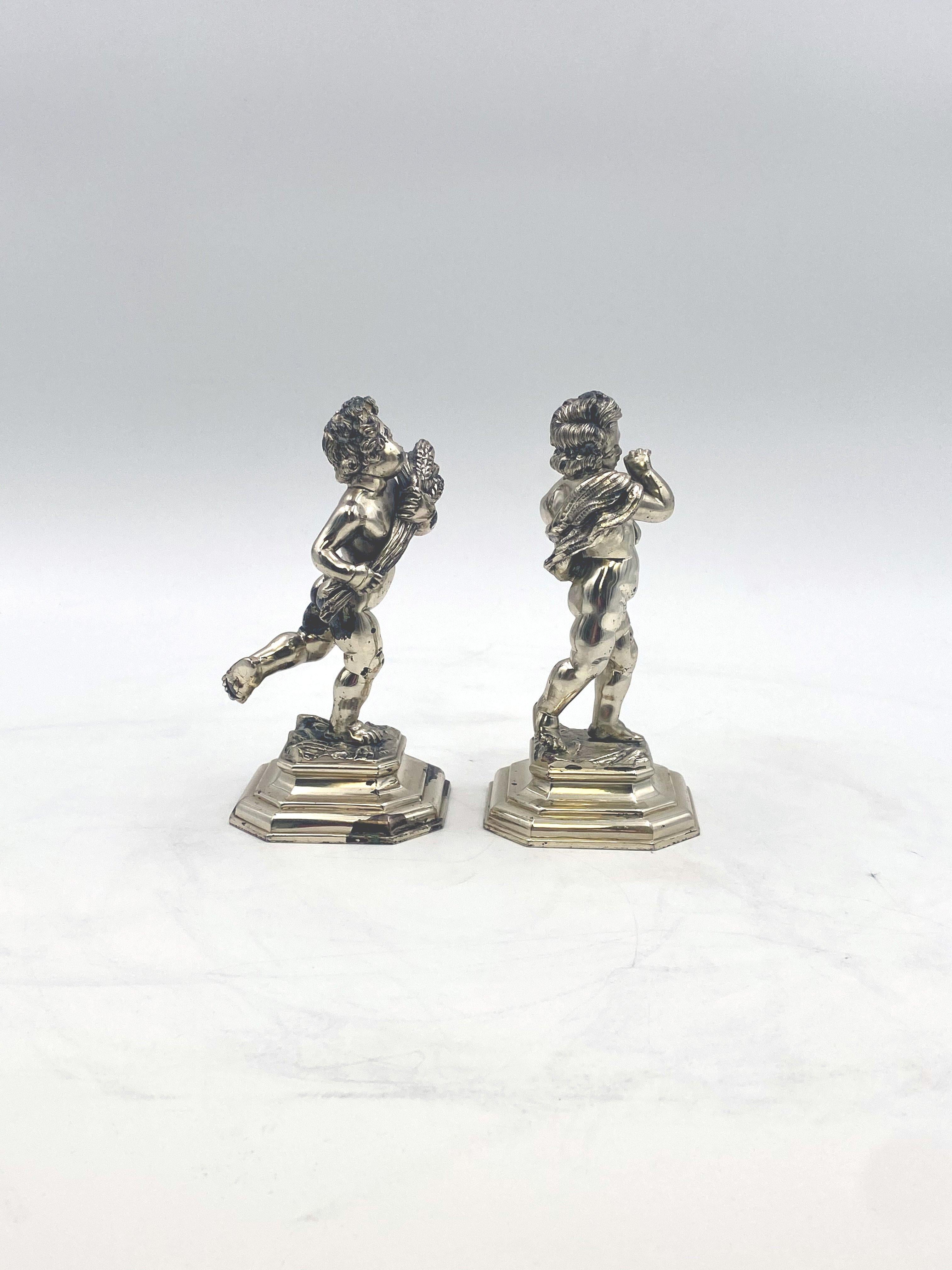 A pair of beautifully chased Italian solid 0.800 silver cherubs with two of the four seasons design. Made in the 20th century. Measurements: Height: 6 inches and Weight: 29.3 ounces. Bearing hallmarks as shown in images.

